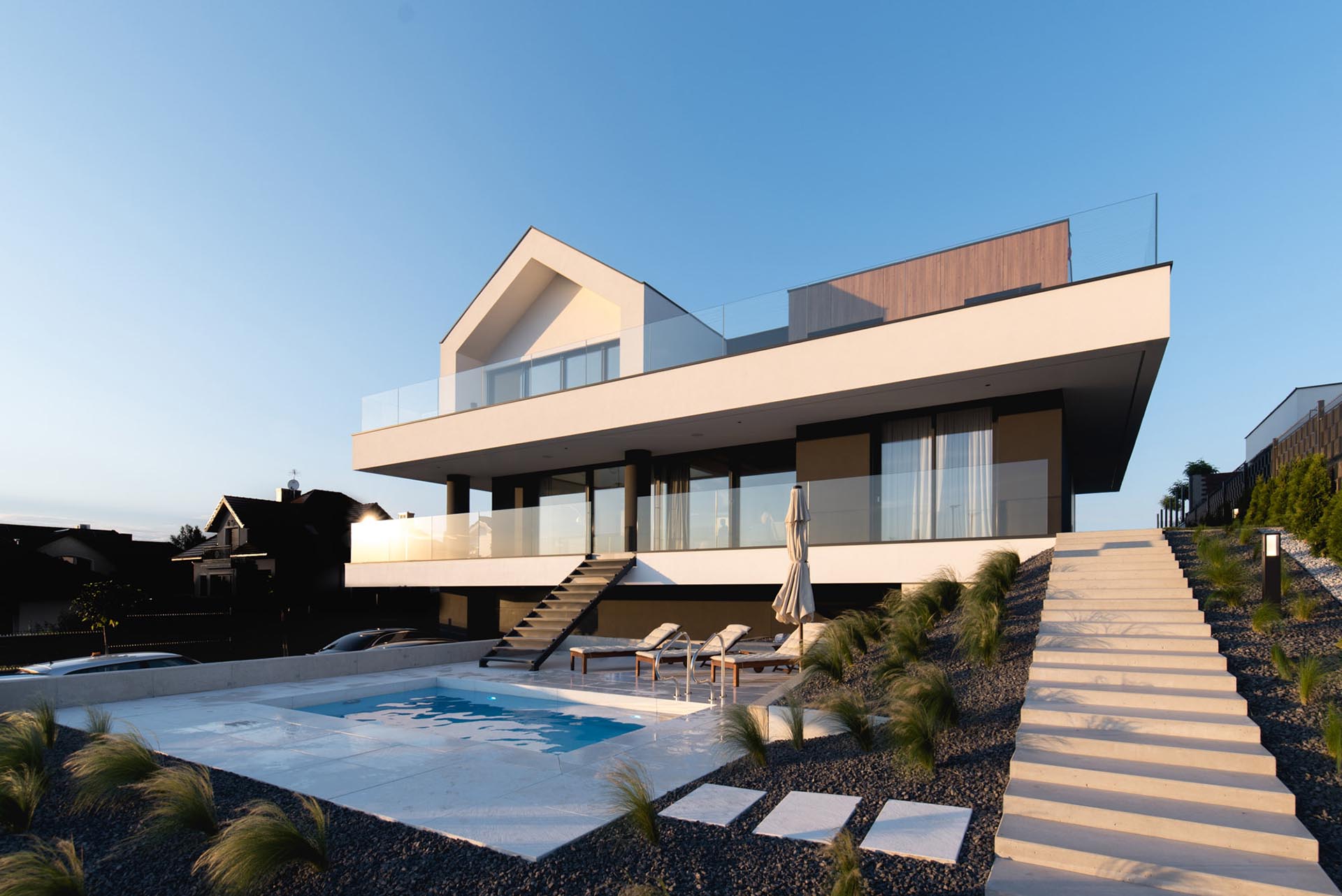 A modern home with a swimming pool and surrounding deck.