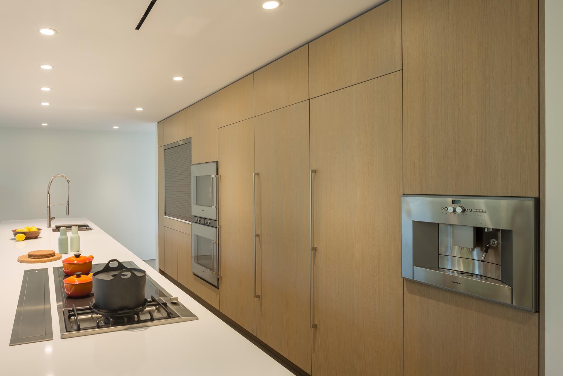 A modern kitchen with minimalist wood cabinets.