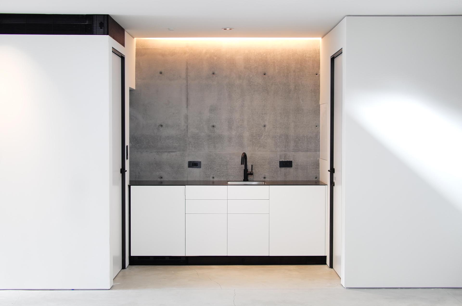 A built-in kitchenette highlighted by hidden lighting.