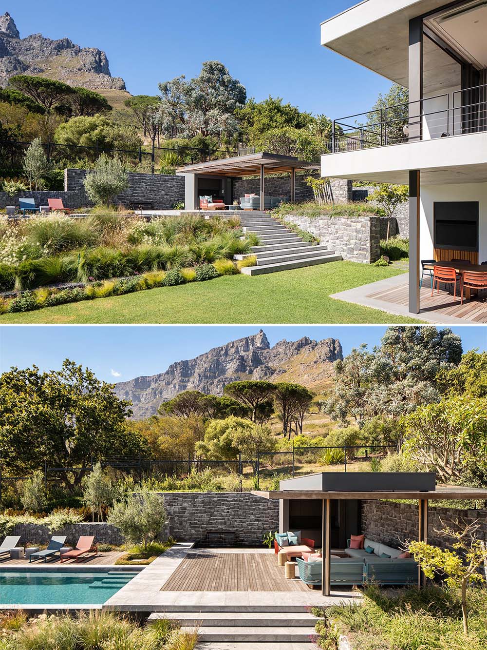 A landscaped yard with an upper level that's dedicated to a swimming pool and pergola.