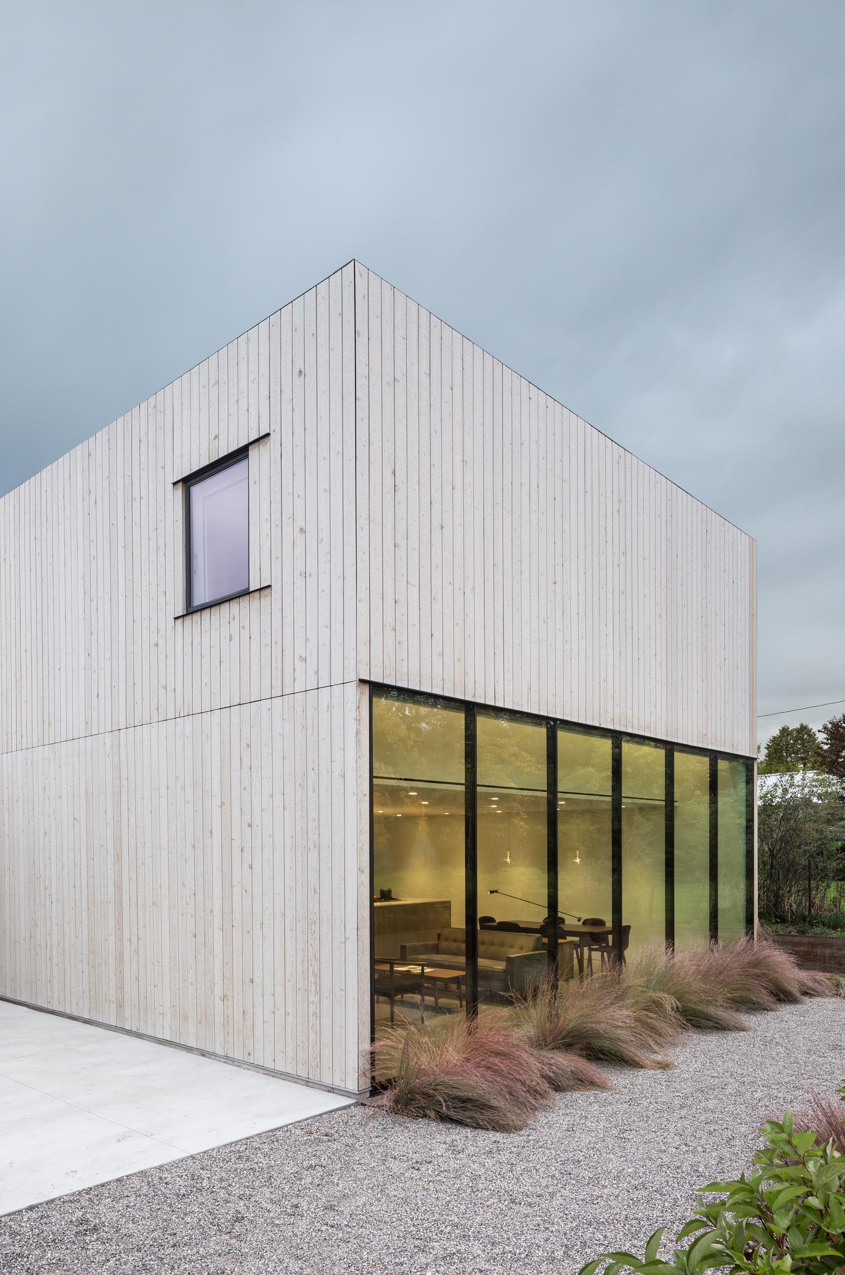 A modern cedar clad home with walls of glass.