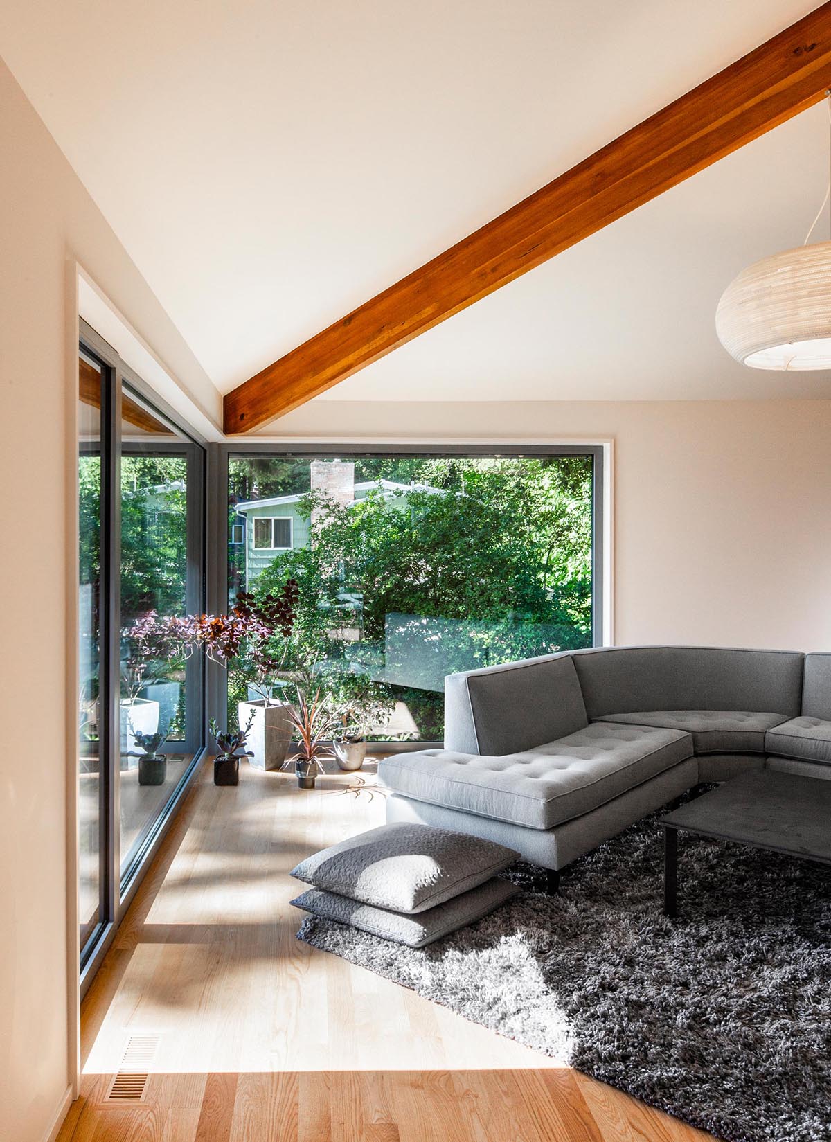 A modern living room with large windows.