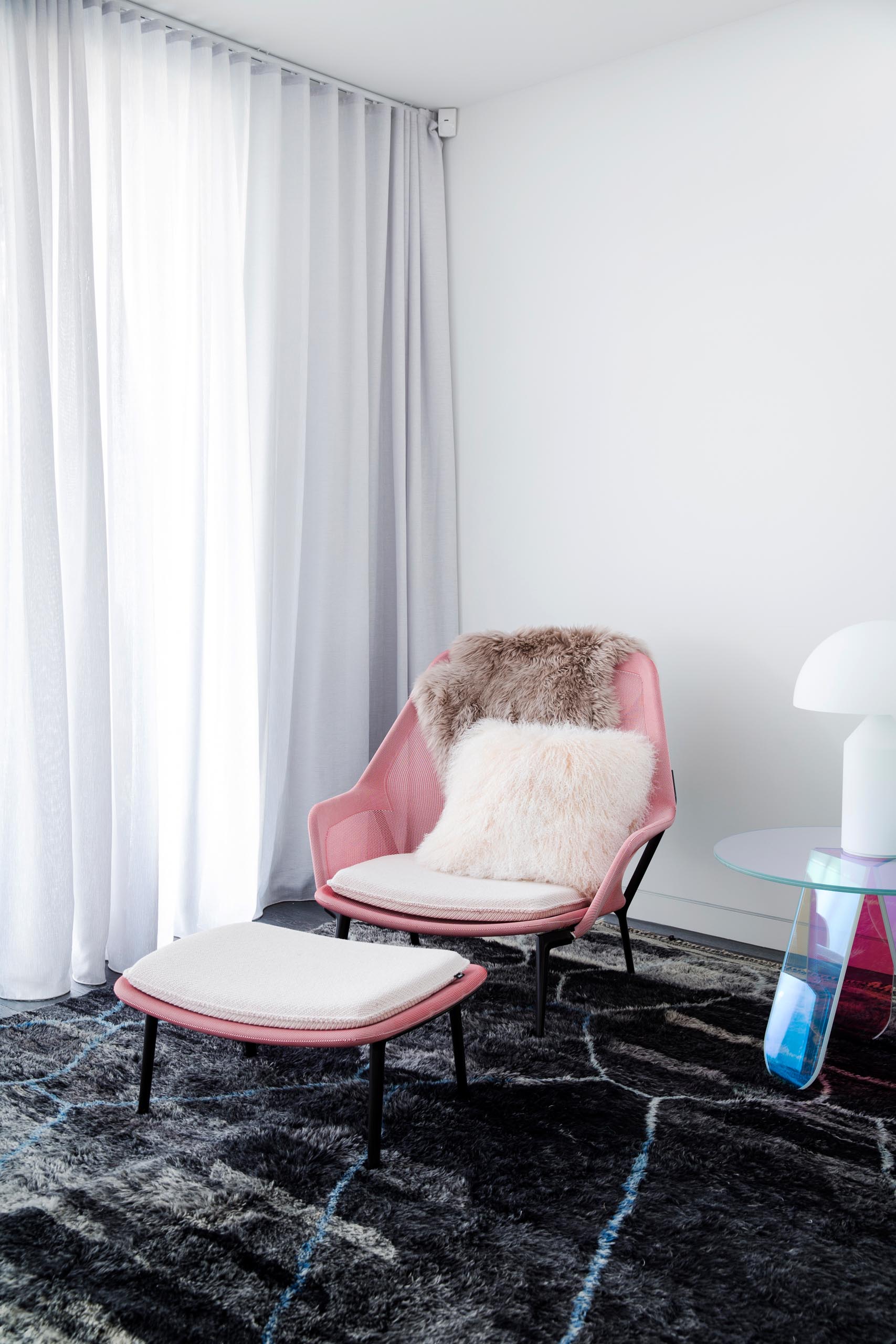 A modern living room with blush pink decorative accents.