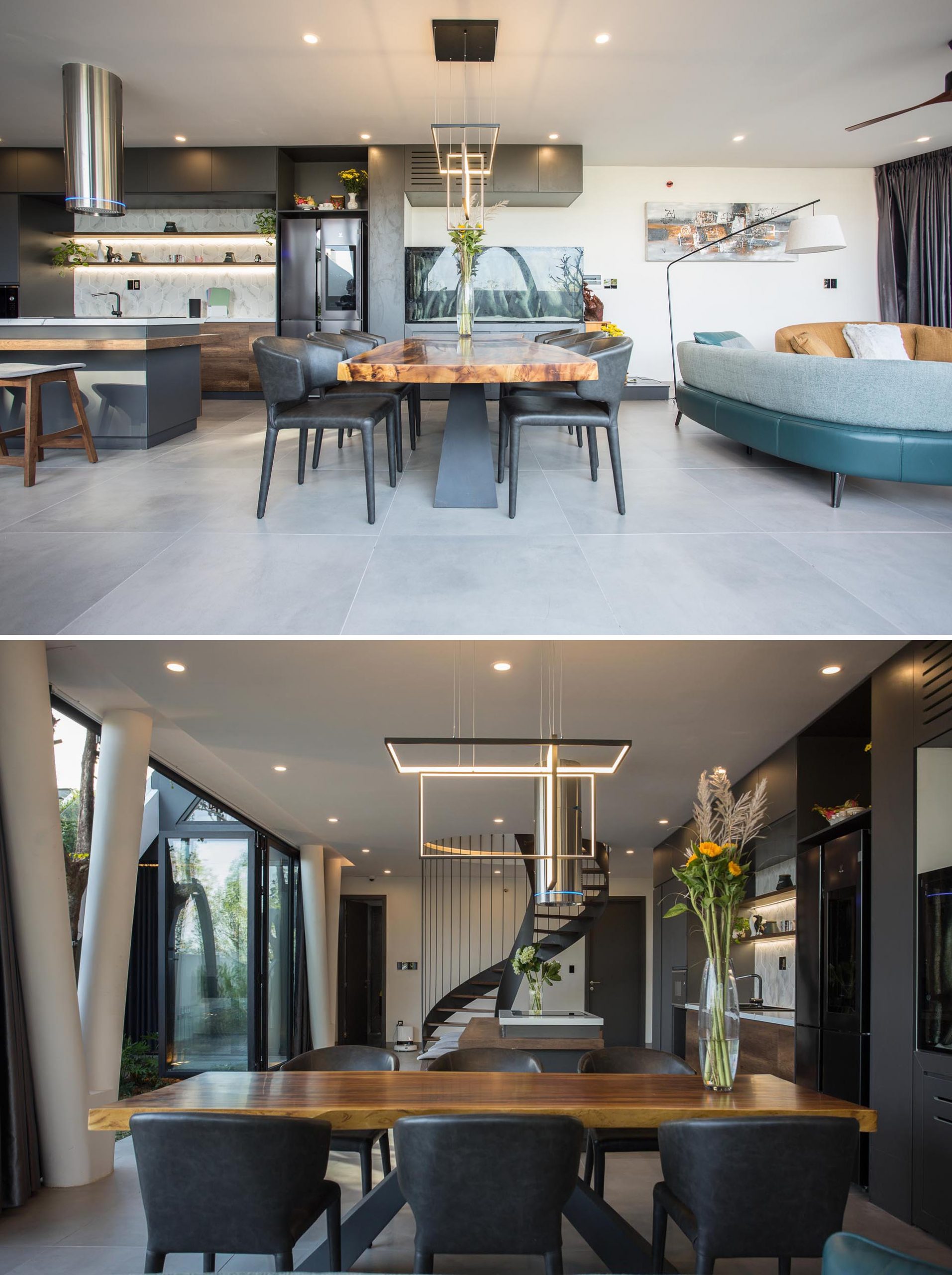 The dining room of this modern home is furnished with a wood top dining table and black chairs, and separates the living room and the kitchen.