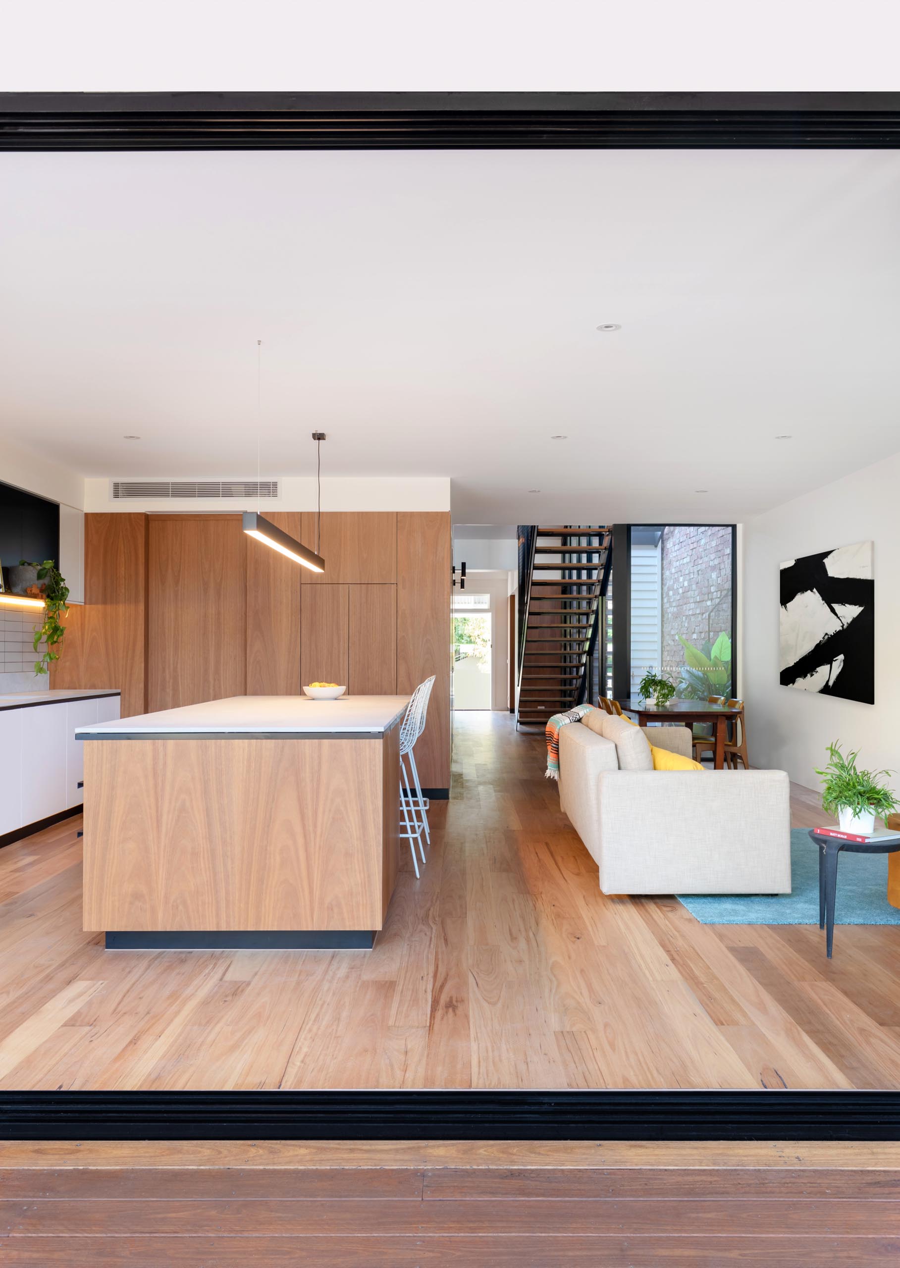 A modern open plan interior with wood flooring.