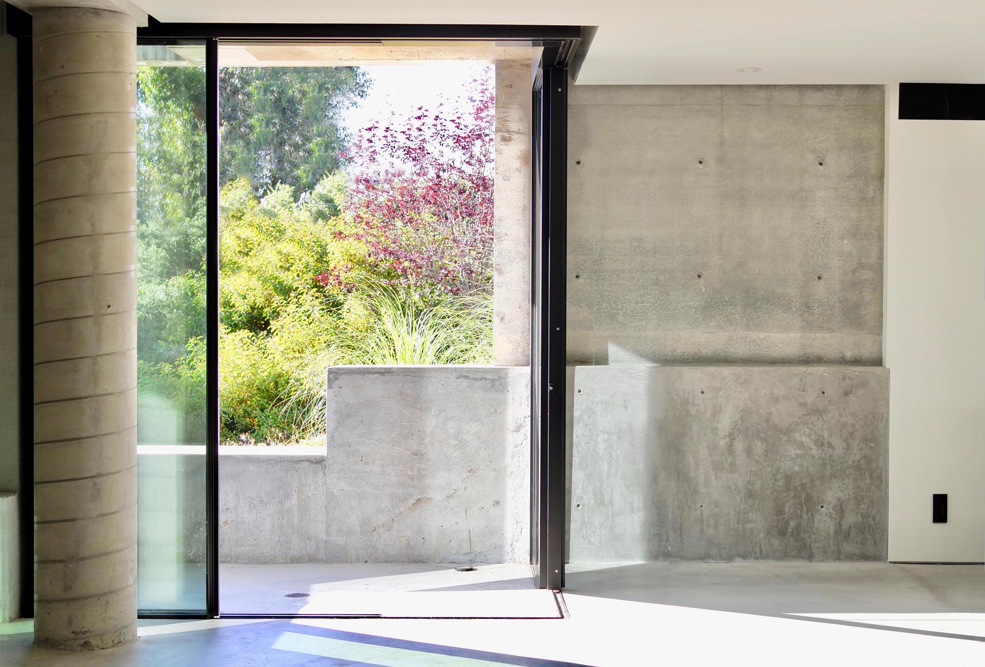 Sliding glass doors open to an underground home office.