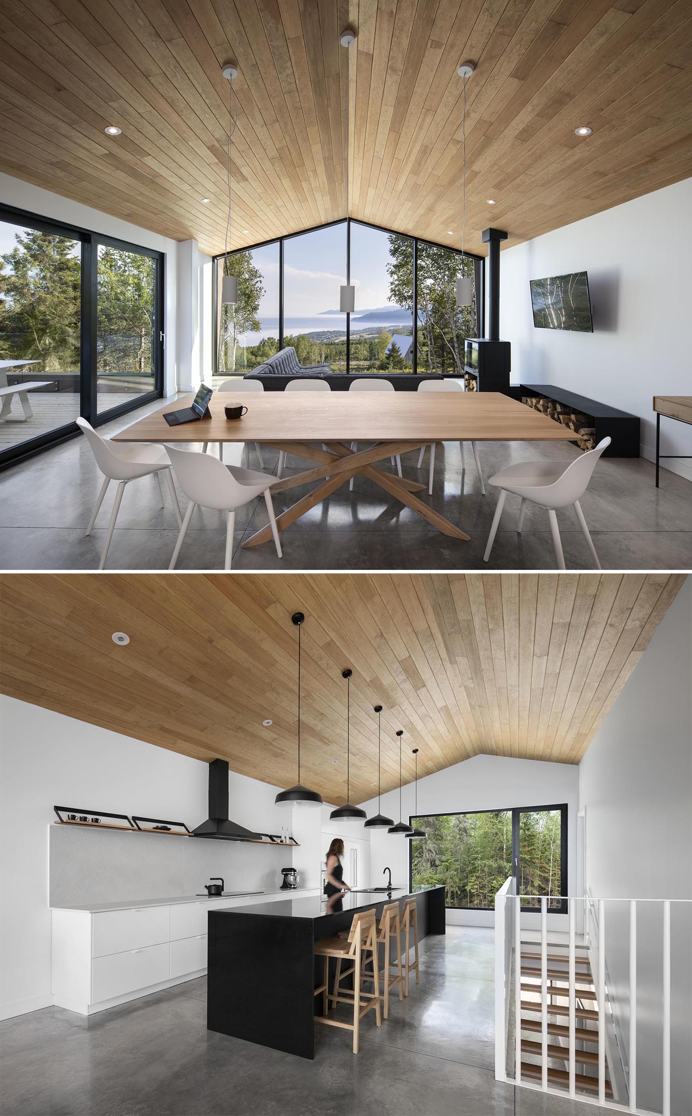 An open plan living room, dining area, and kitchen all share the same vaulted wood ceiling and concrete floors.