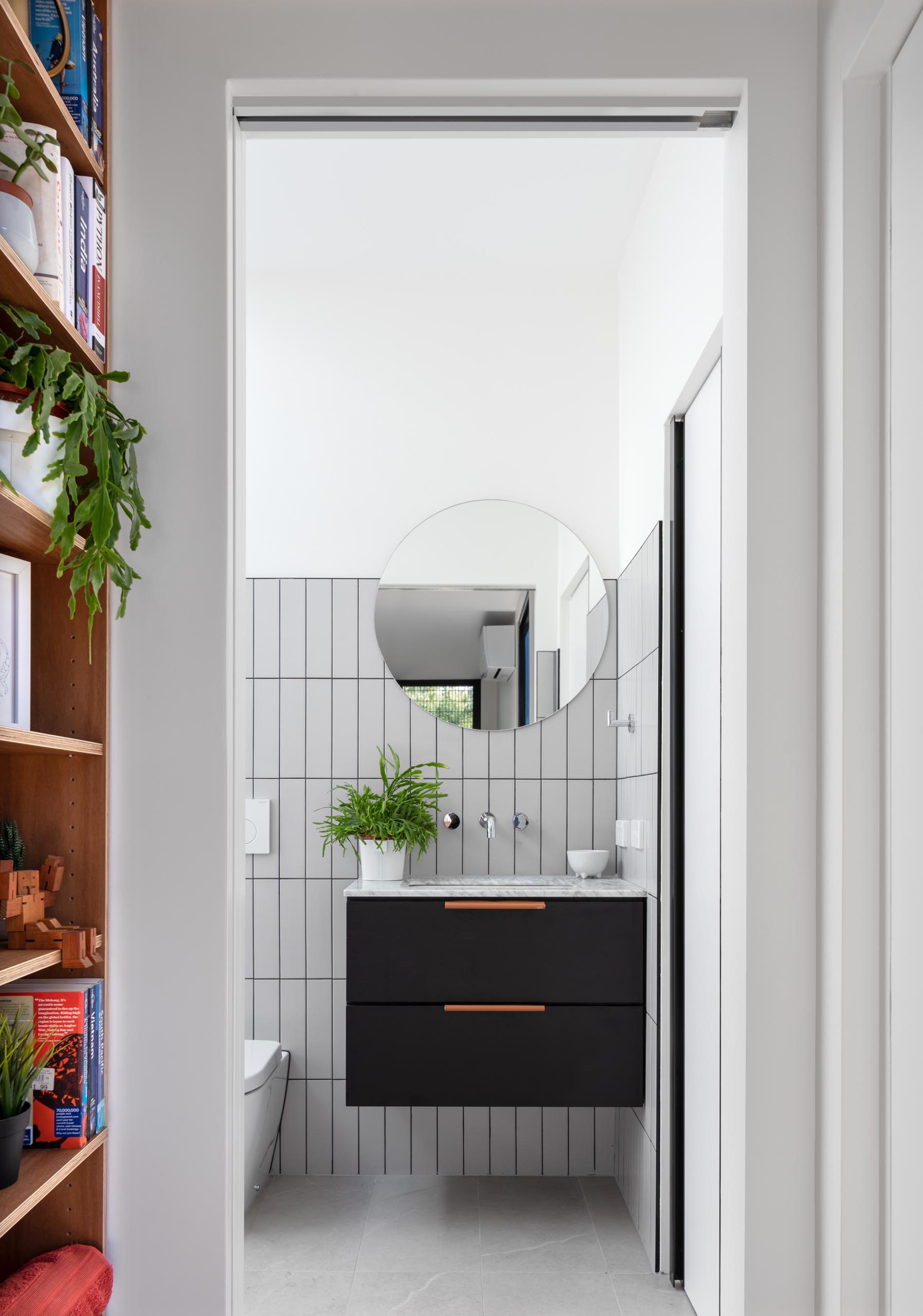 A modern grey, white, and black bathroom.