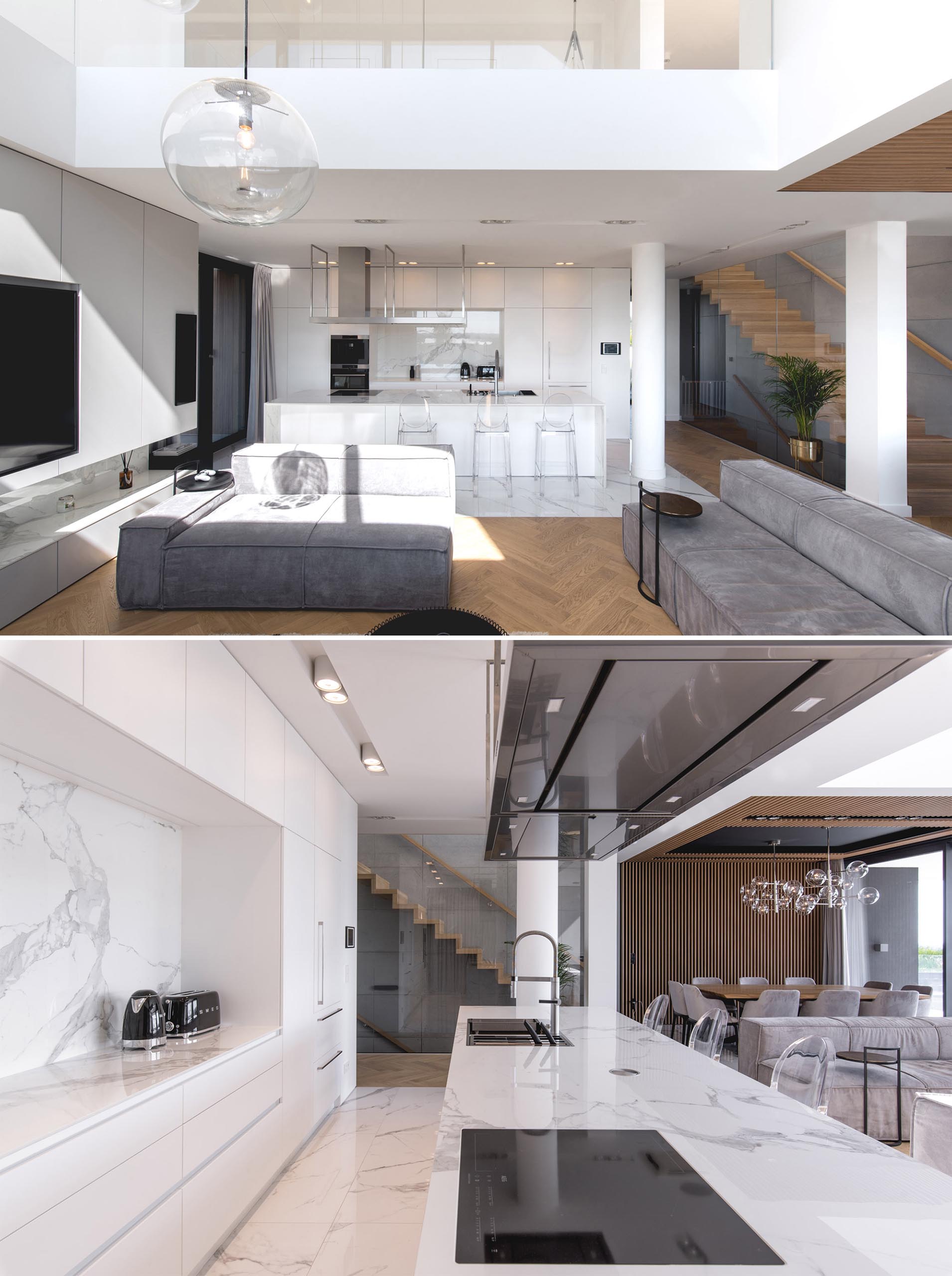 A modern kitchen with minimalist white cabinets that line the wall, and a large island adds extra counter space.