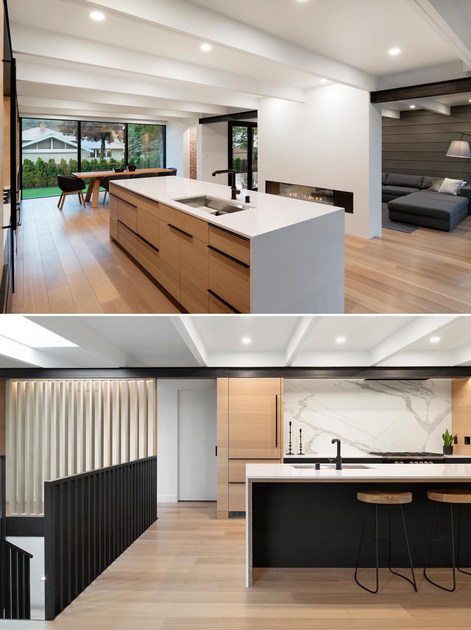 Wood kitchen cabinets are accented by minimalist black hardware and white countertops.