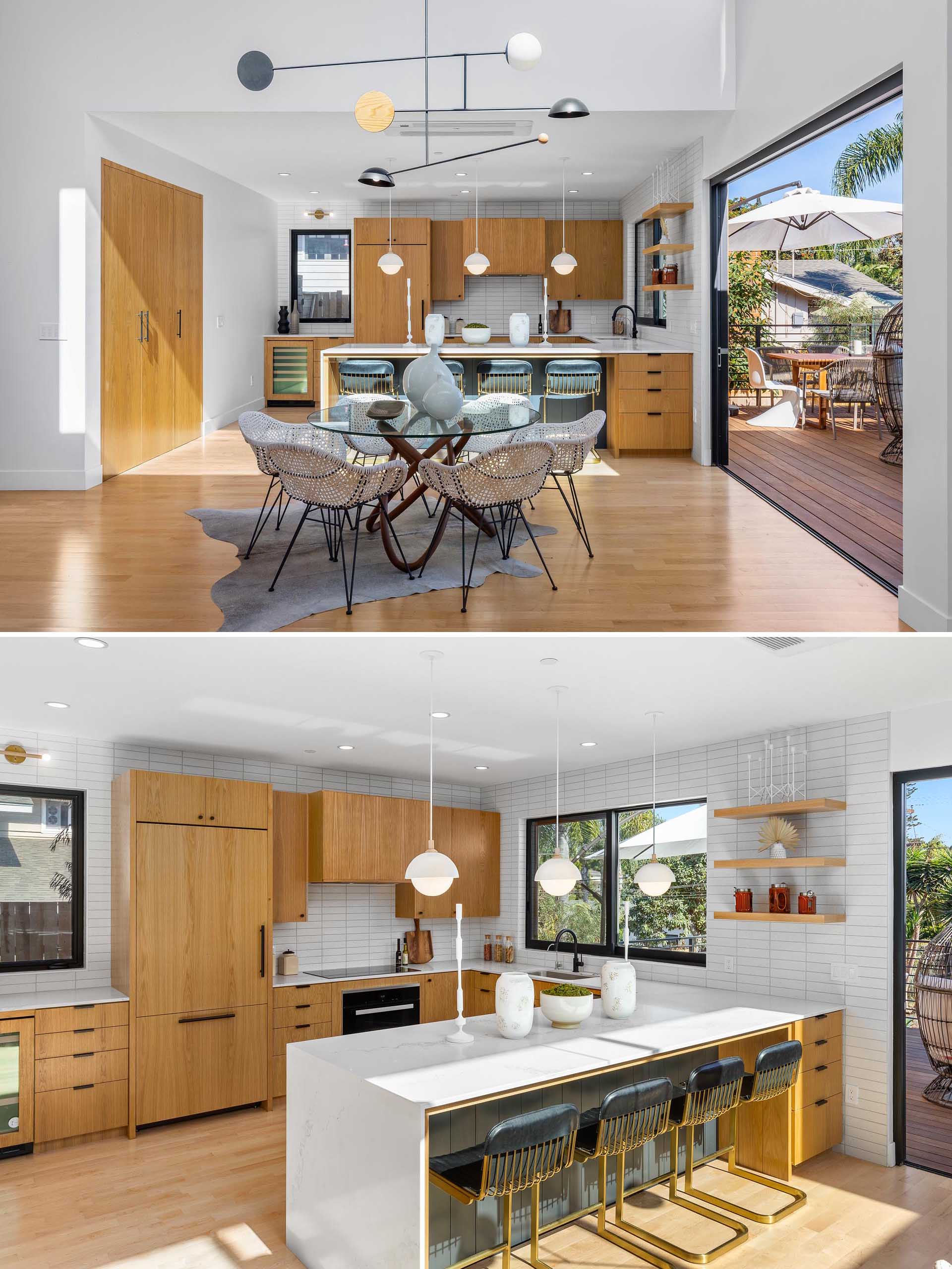 In this modern kitchen, wood cabinetry adds warmth to the interior, while the white countertops and tiles complement the white walls, and help to keep the interior bright.