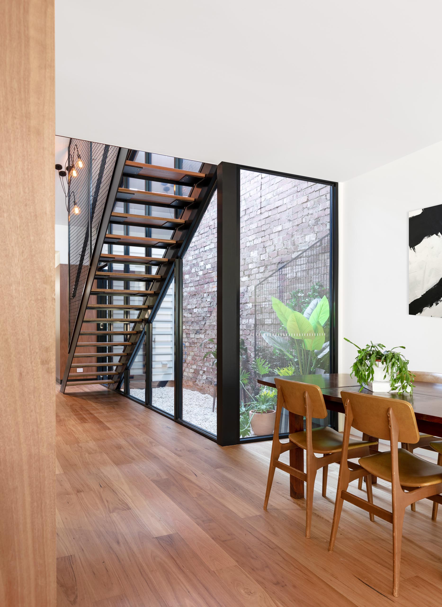 A modern home with a small outdoor courtyard and blackbutt wood flooring.