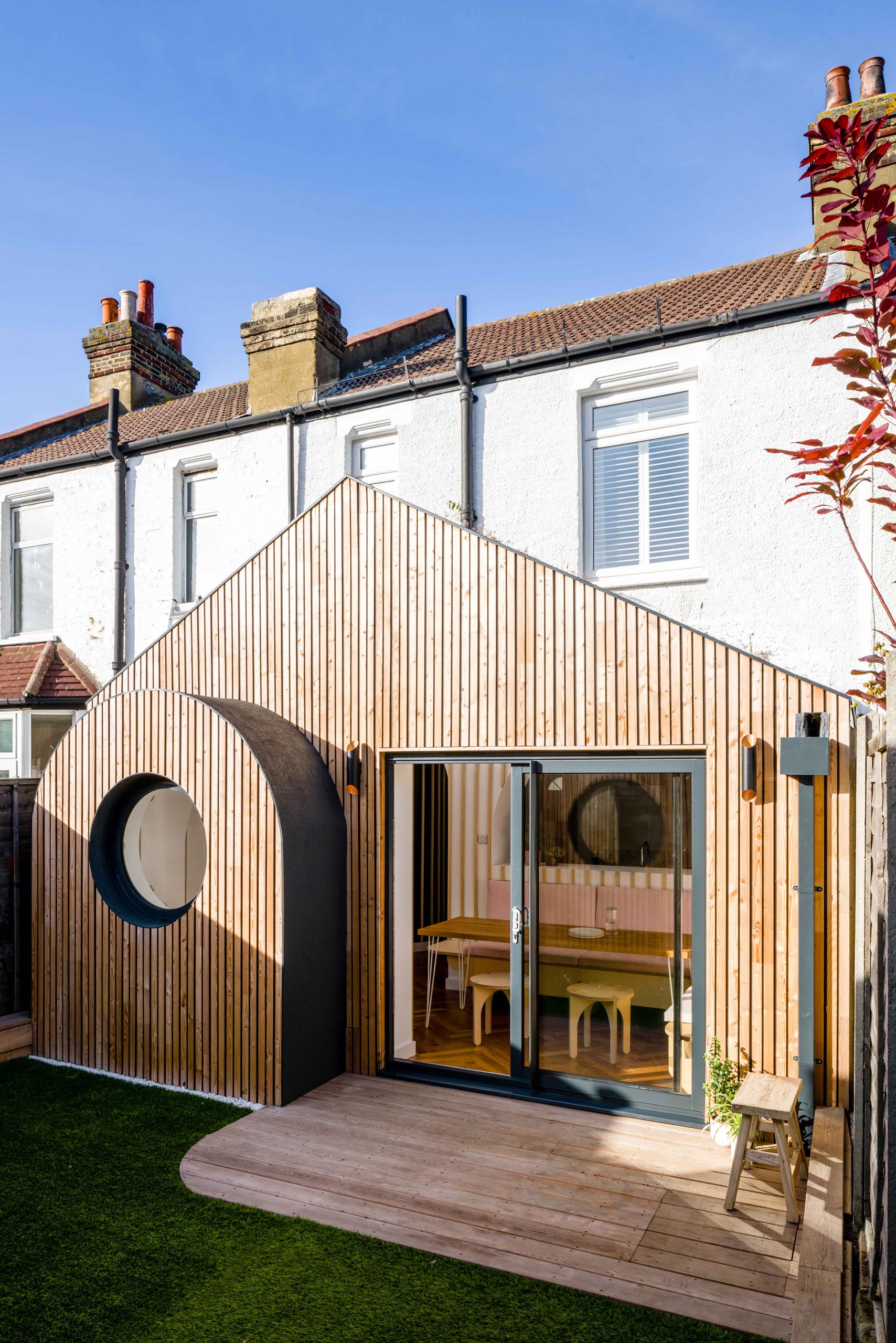 This modern house addition features tongue-and-groove larch cladding.