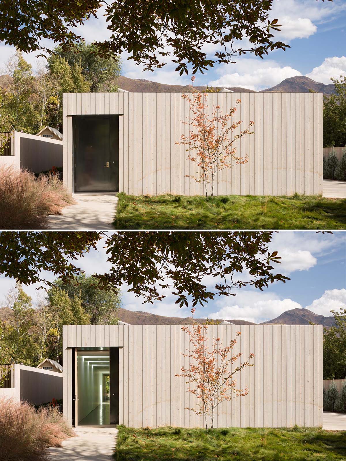 A modern cedar clad home with a black front door.