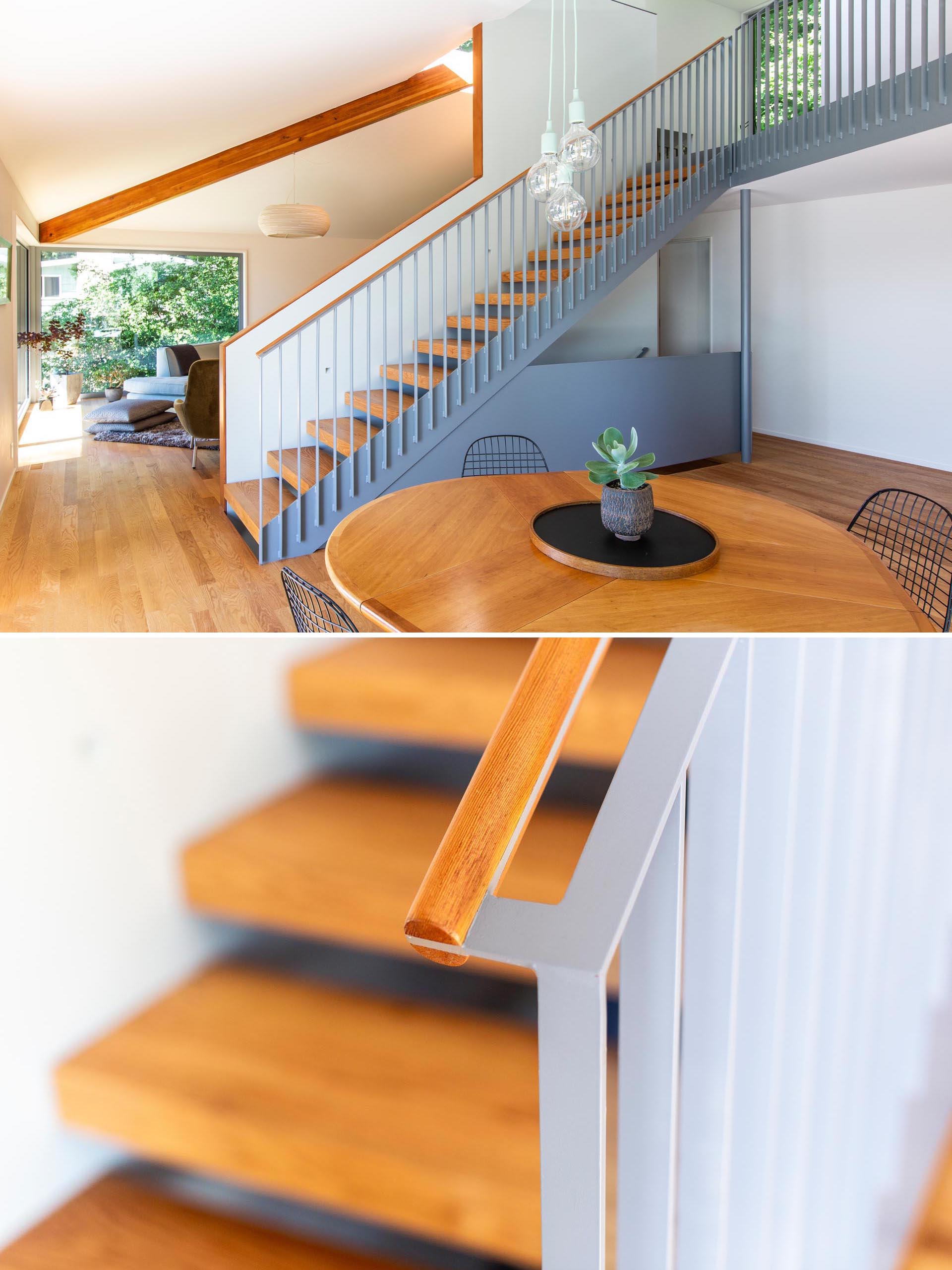 Matte gray and wood stairs connect the main level of this modern home with the upper floor.