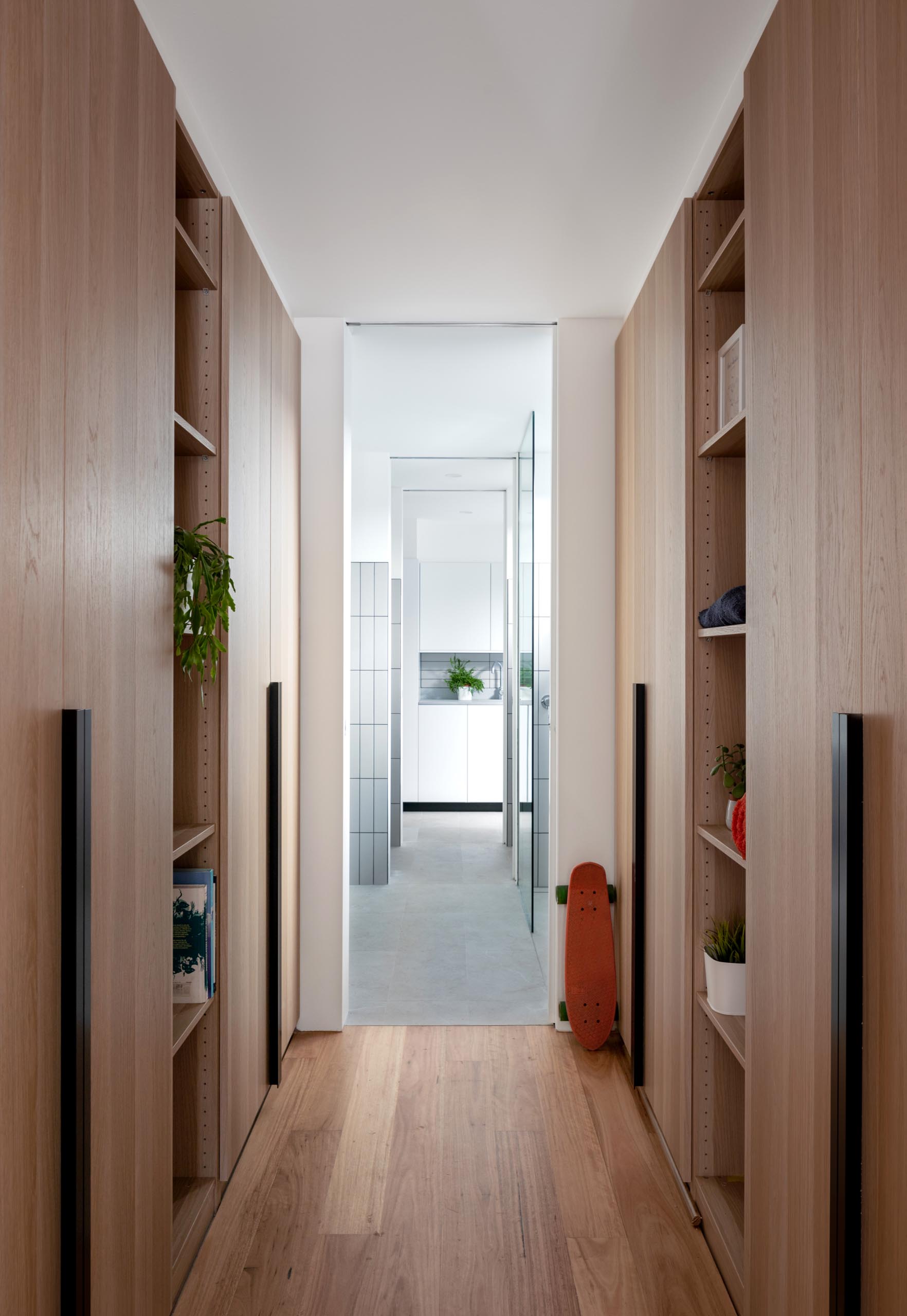 A modern wood walk-through closet.