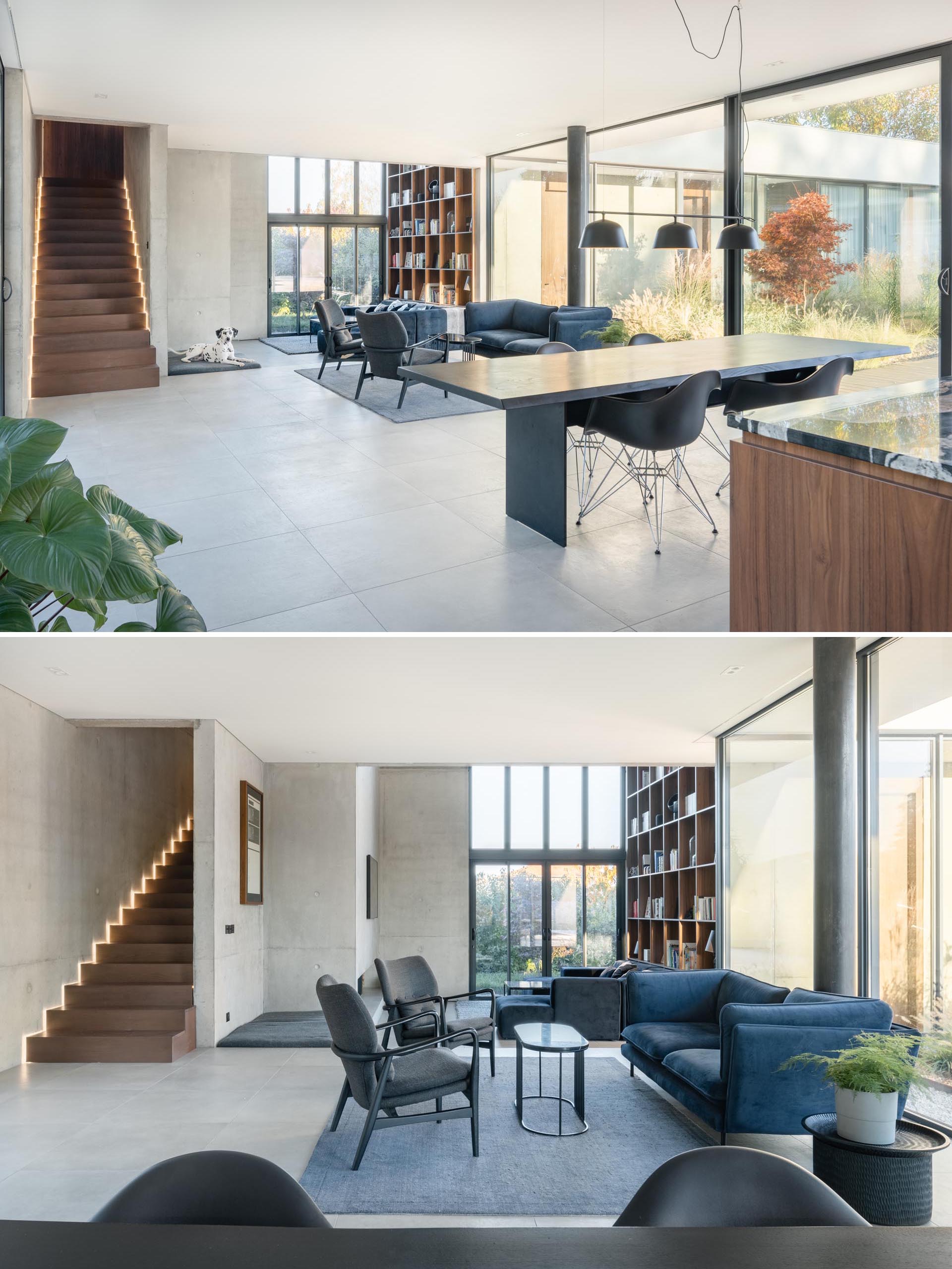 The living and dining areas of this modern home are open plan, with a few steps separating the two spaces. There's also a small ledge that's a dedicated space for a dog bed.