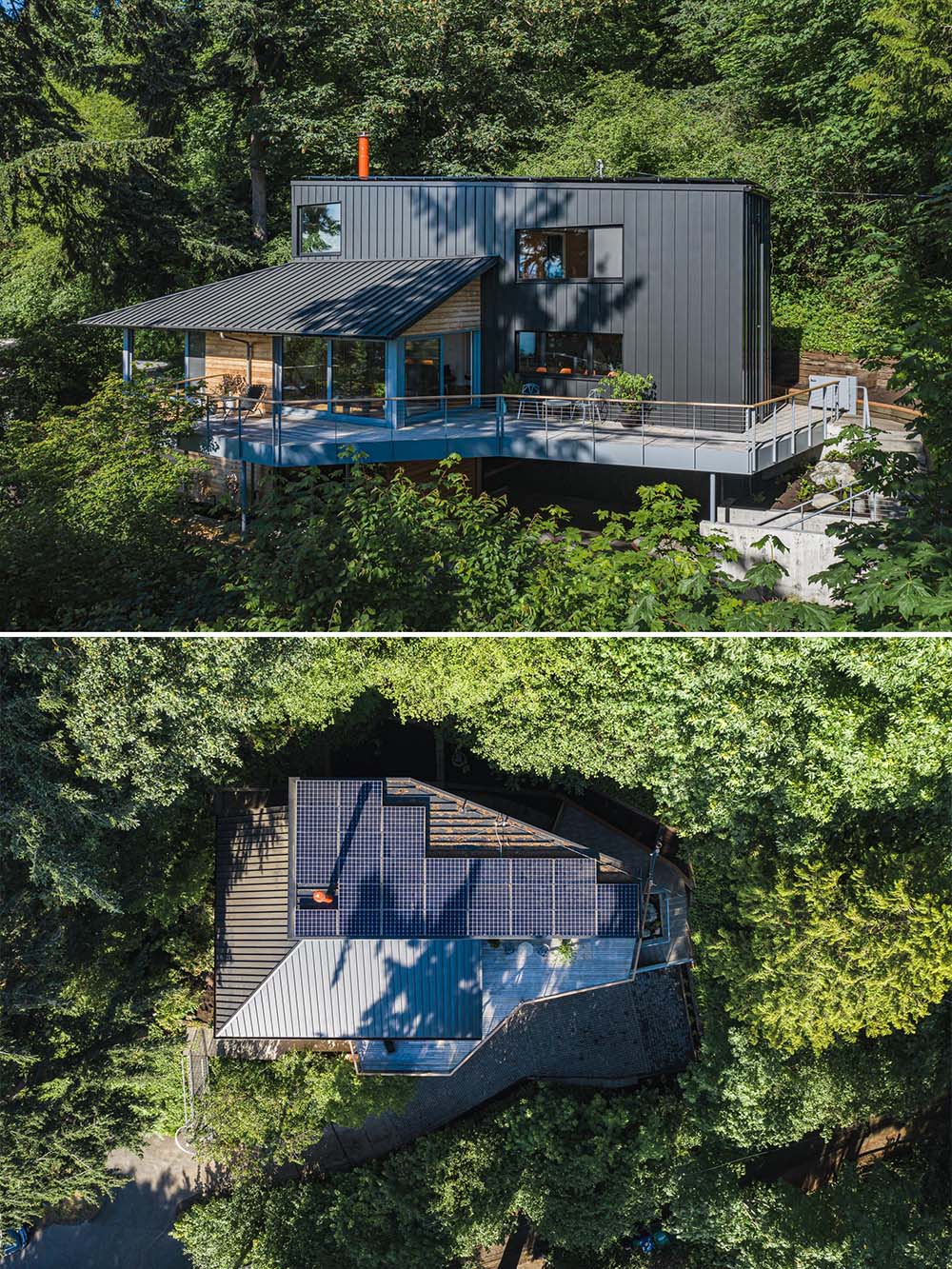 Located on a steep site, the updated black metal and wood exterior of this home is topped with solar panels on the roof.