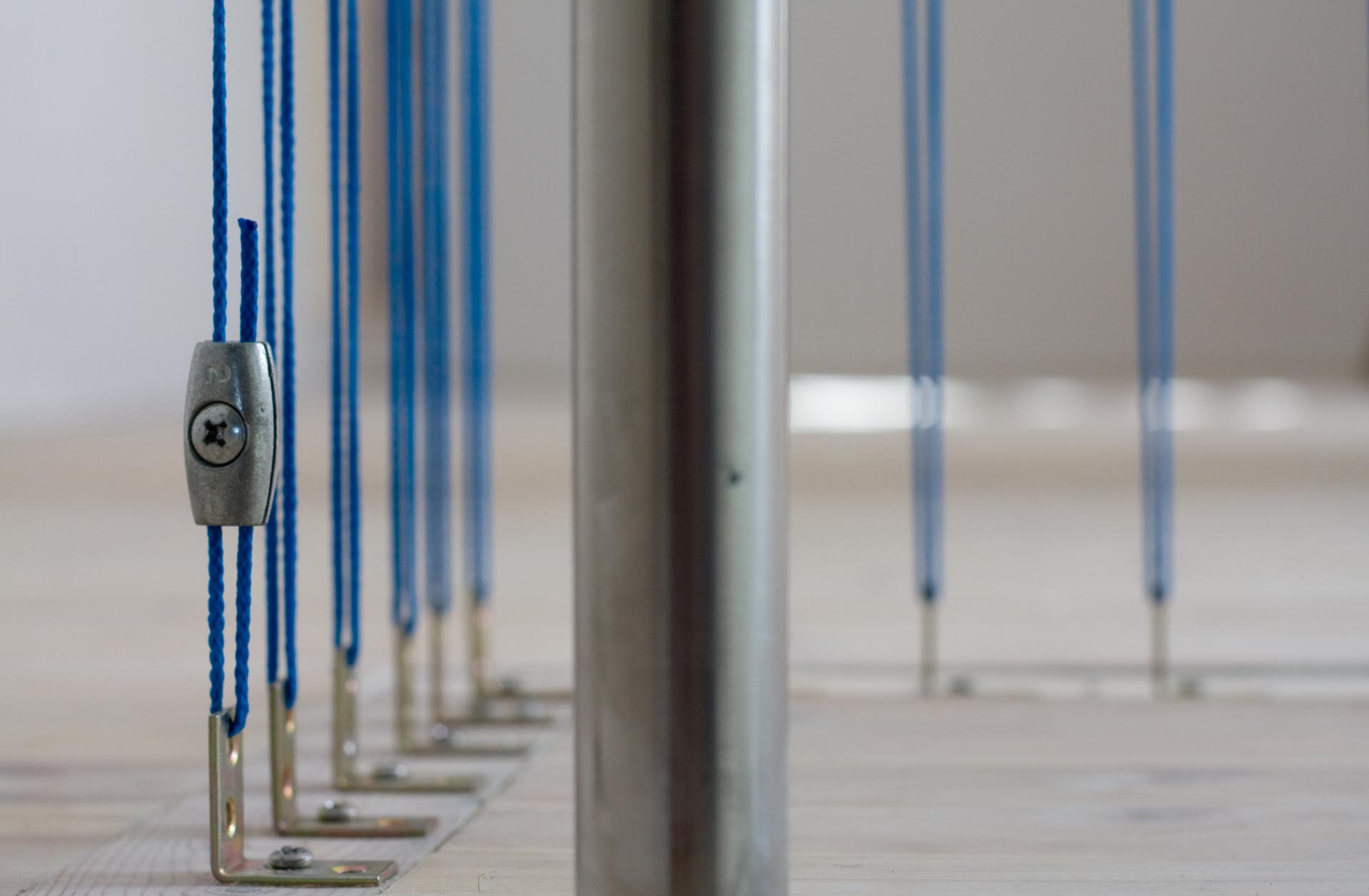 Modern stairs with a blue rope safety barrier.