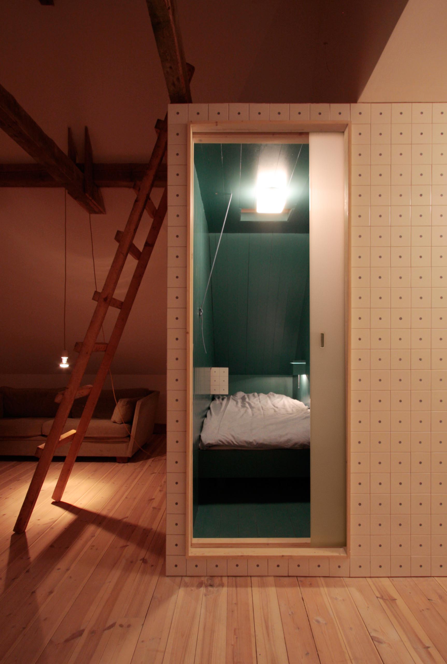 A modern turquoise blue bedroom that has exterior walls covered in tiles.