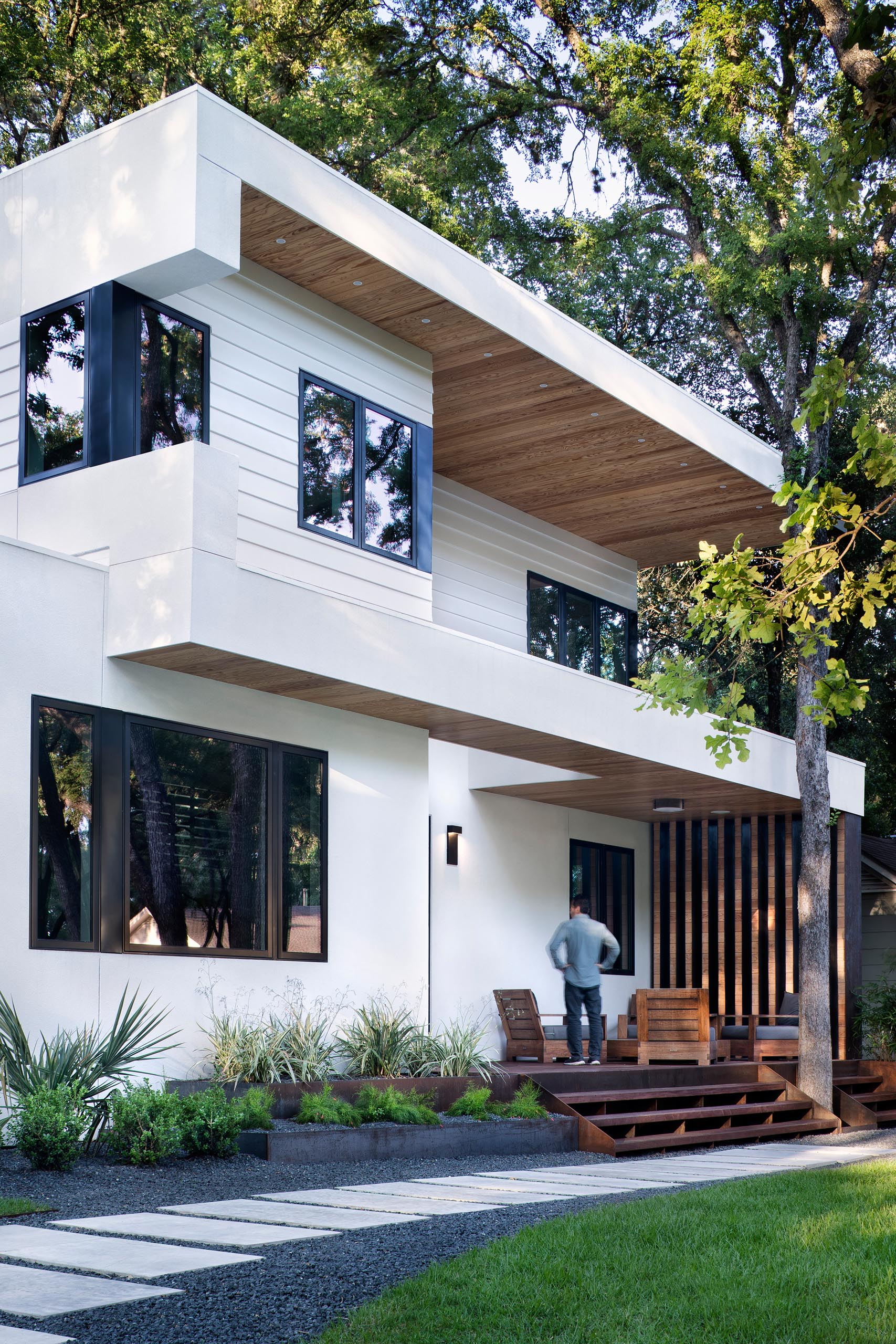 A modern white house with a front porch.