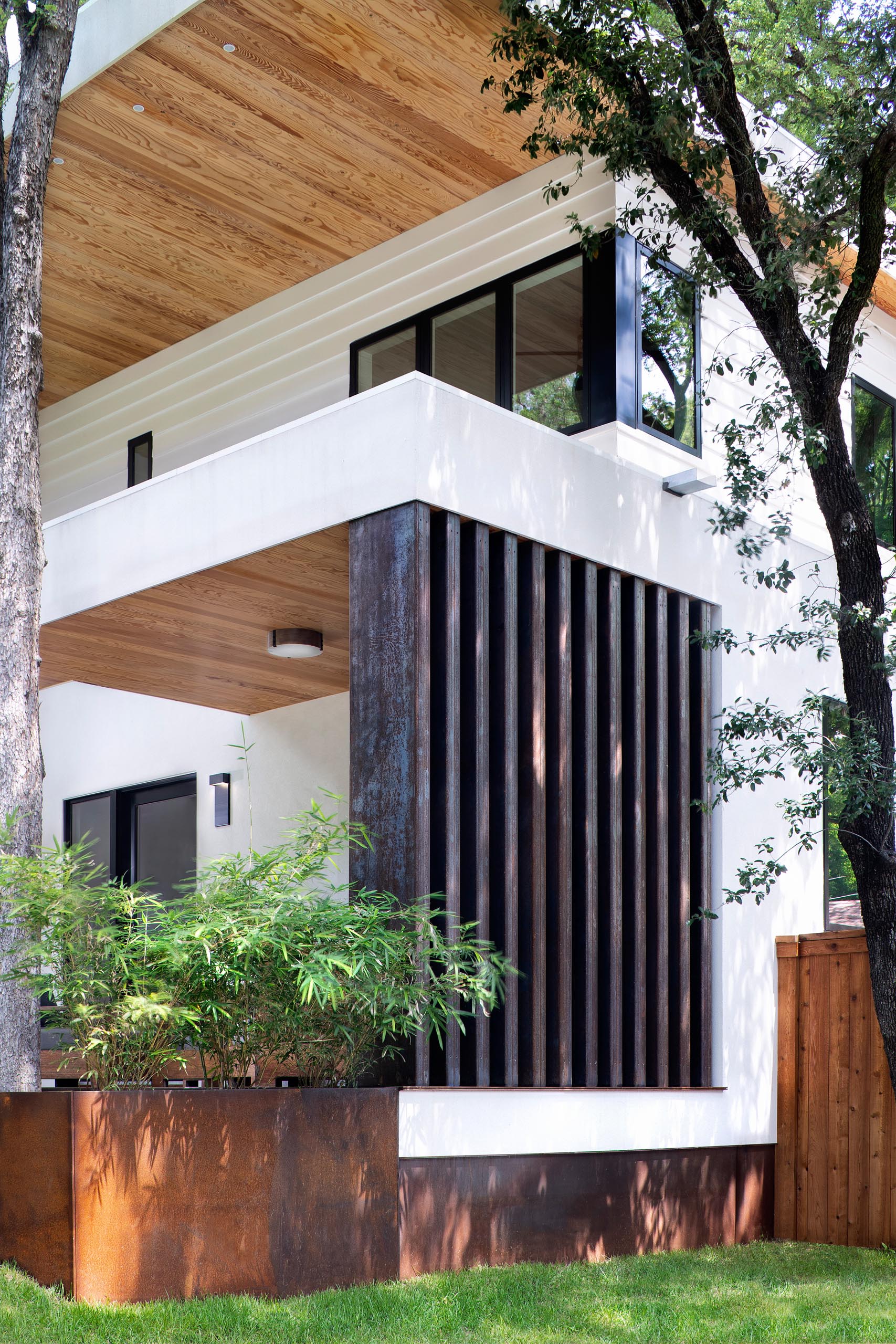 A modern house with a white exterior and steel accents.