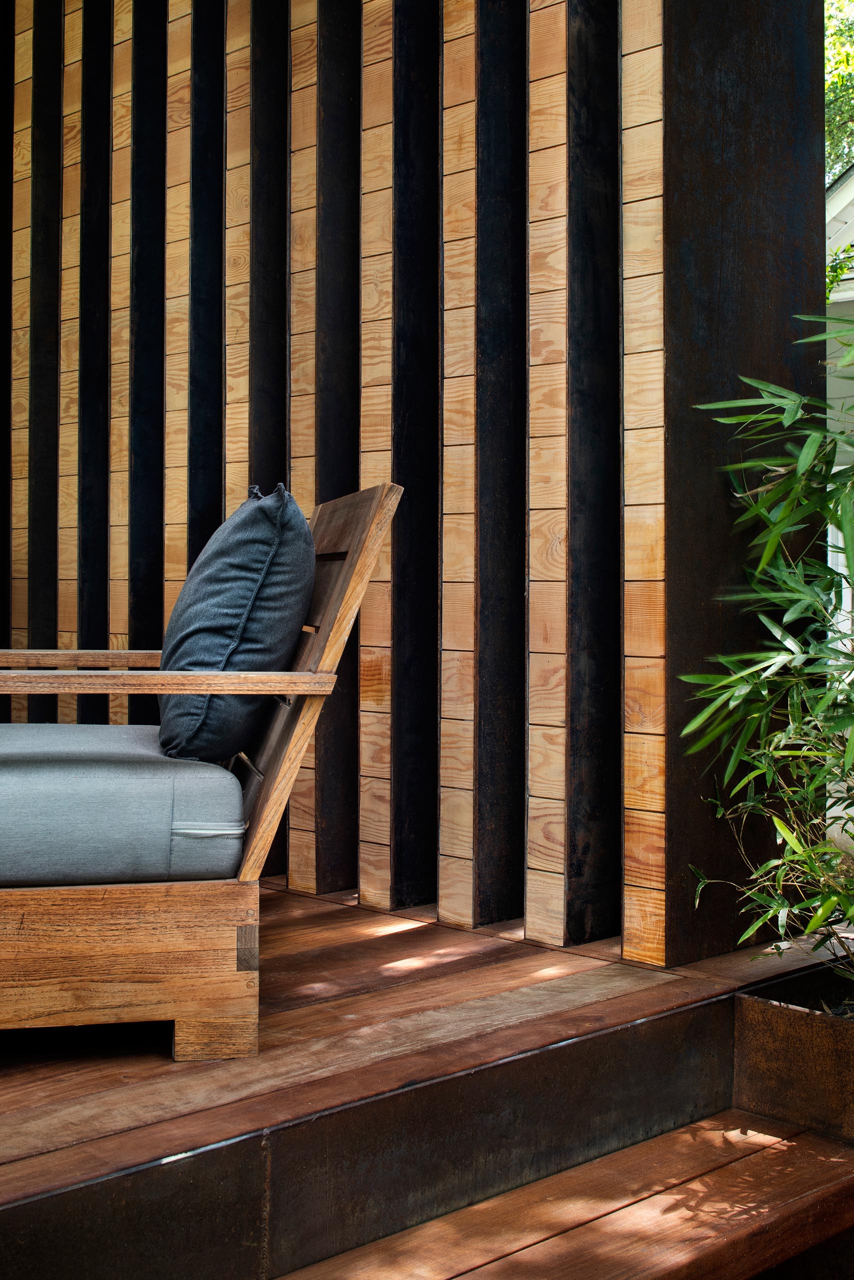 A modern wood front porch with steel accent.