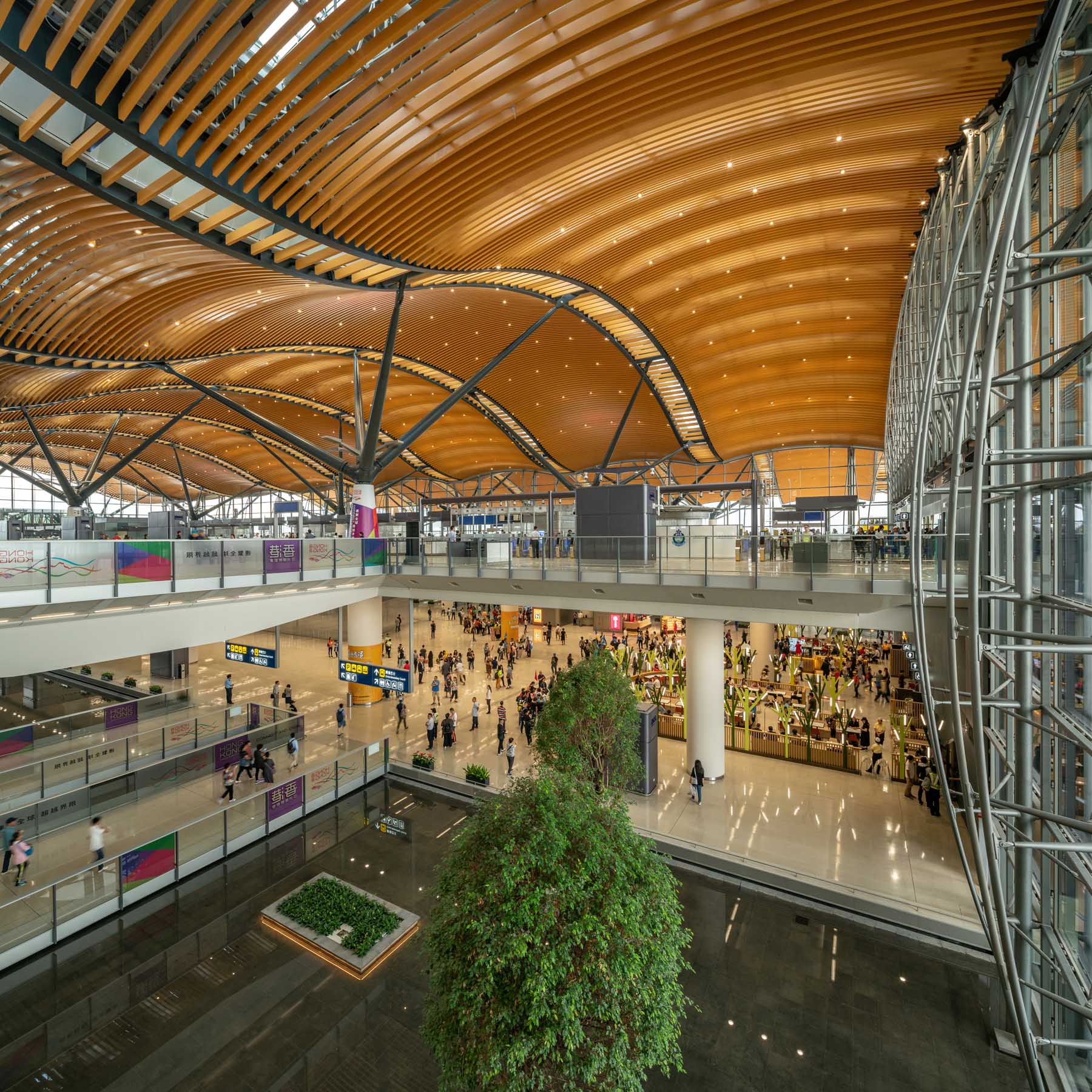 A modern building with a wavy wood roof.