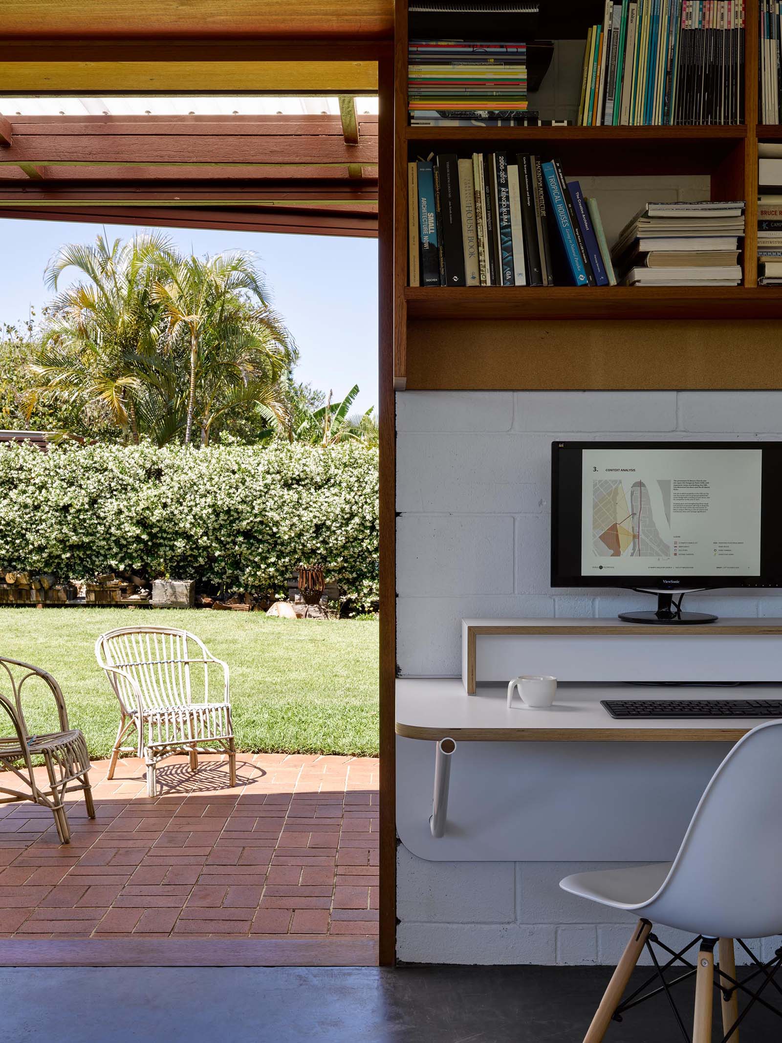 A backyard home office with a brick patio.