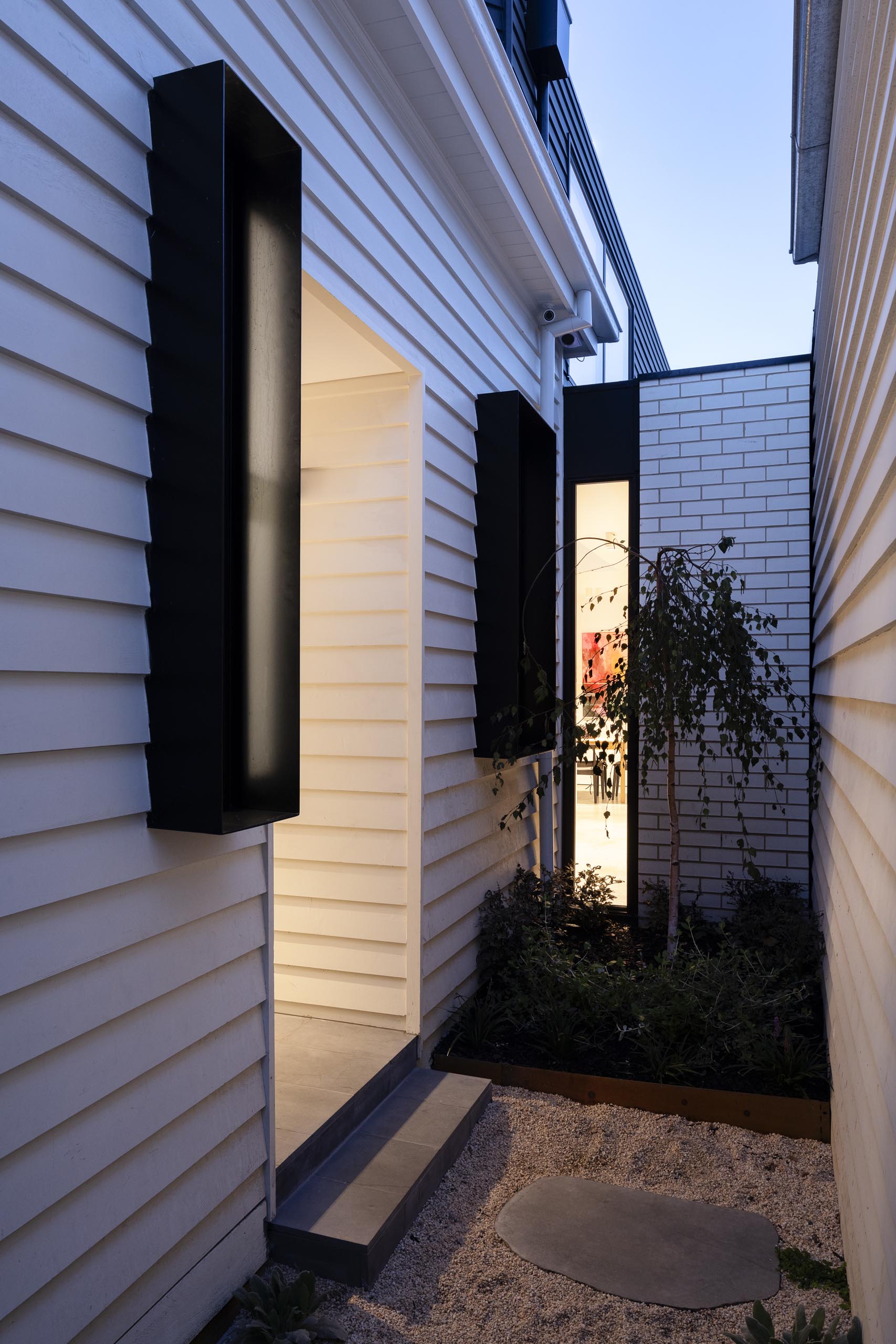 A remodeled house with a side entrance.