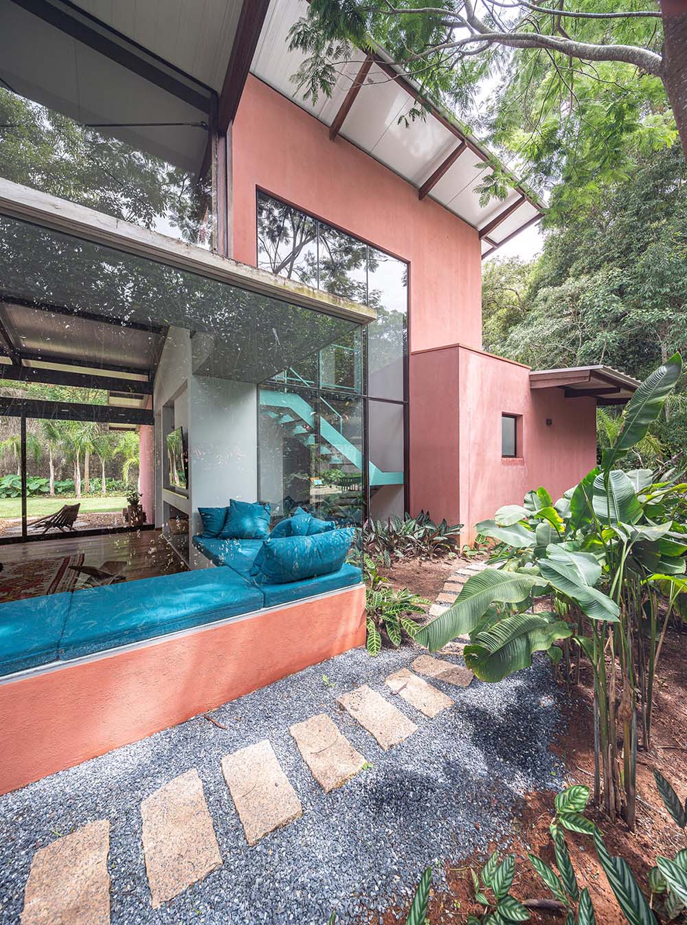 Rocco Arquitetos has completed the 'Itauba House' in Sao Paulo, Brazil, that includes a wrap-around corner window bench as part of the overall design.