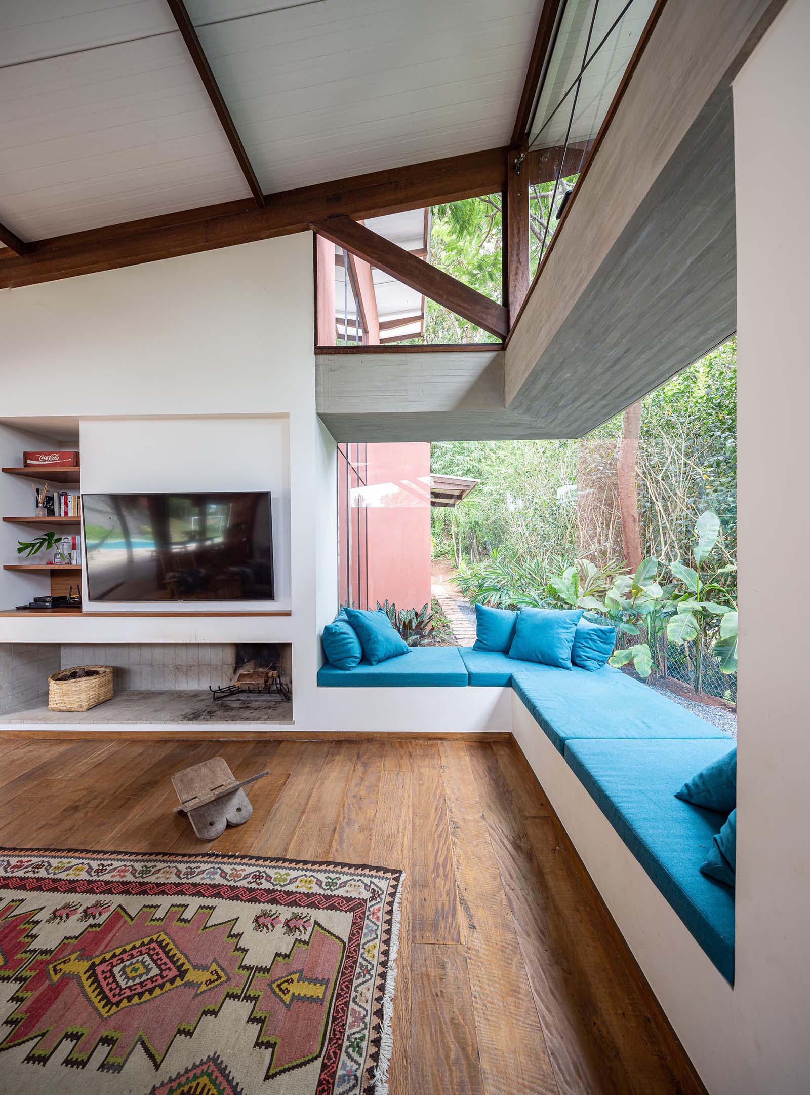 The bright blue upholstered cushions and pillows adds a bright and colorful accent to the room, while the window bench is long enough to accommodate multiple people.