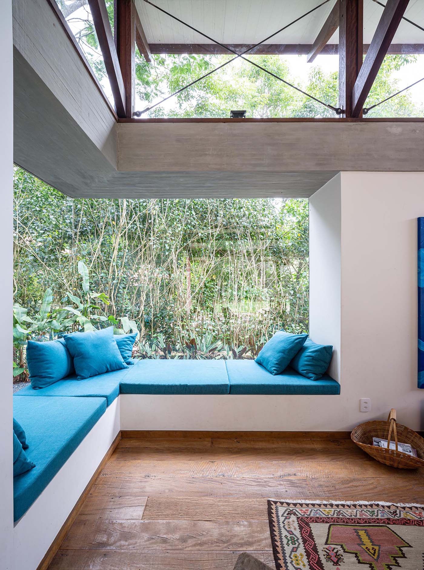 The bright blue upholstered cushions and pillows adds a bright and colorful accent to the room, while the window bench is long enough to accommodate multiple people.