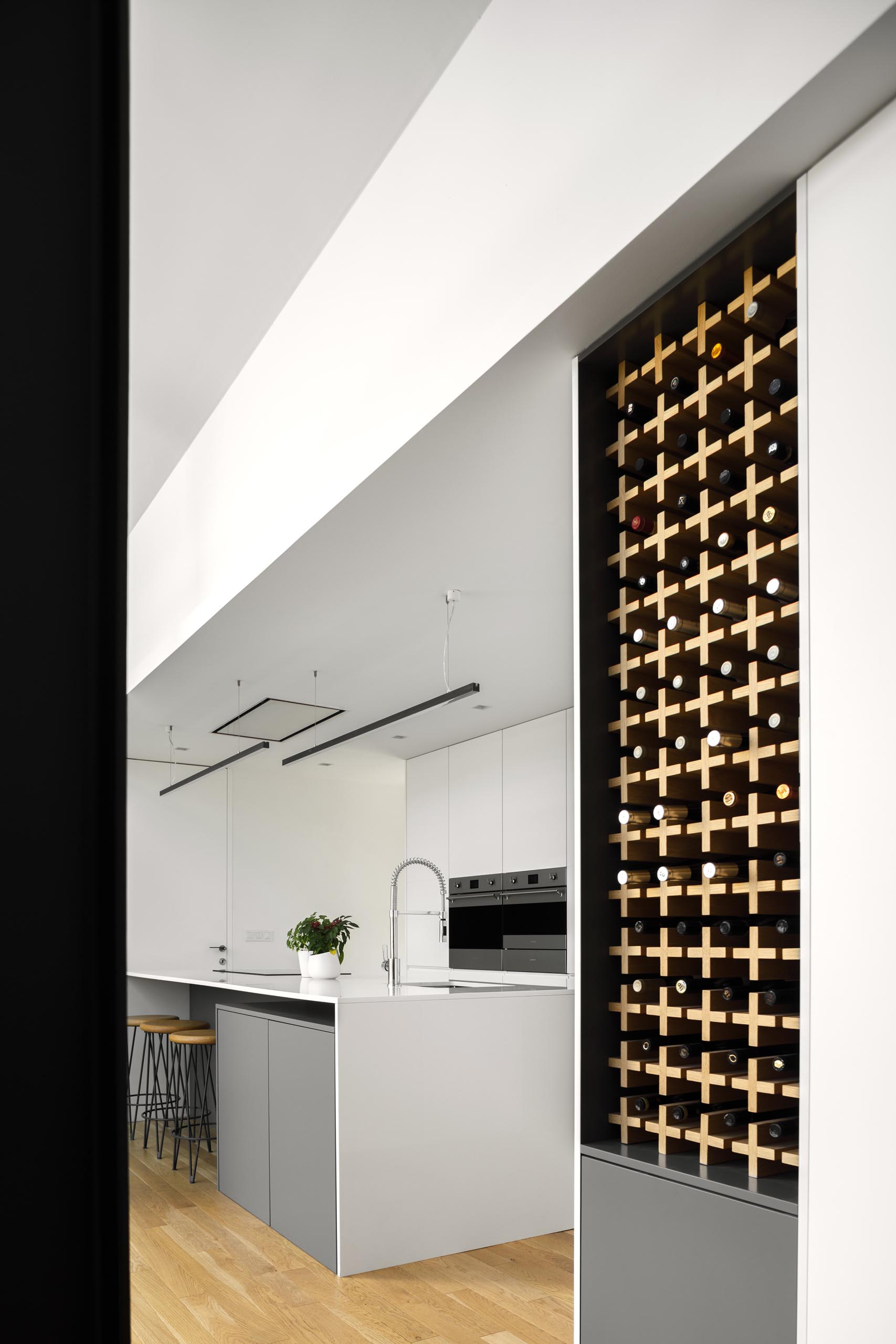 A modern kitchen with built-in wine storage.