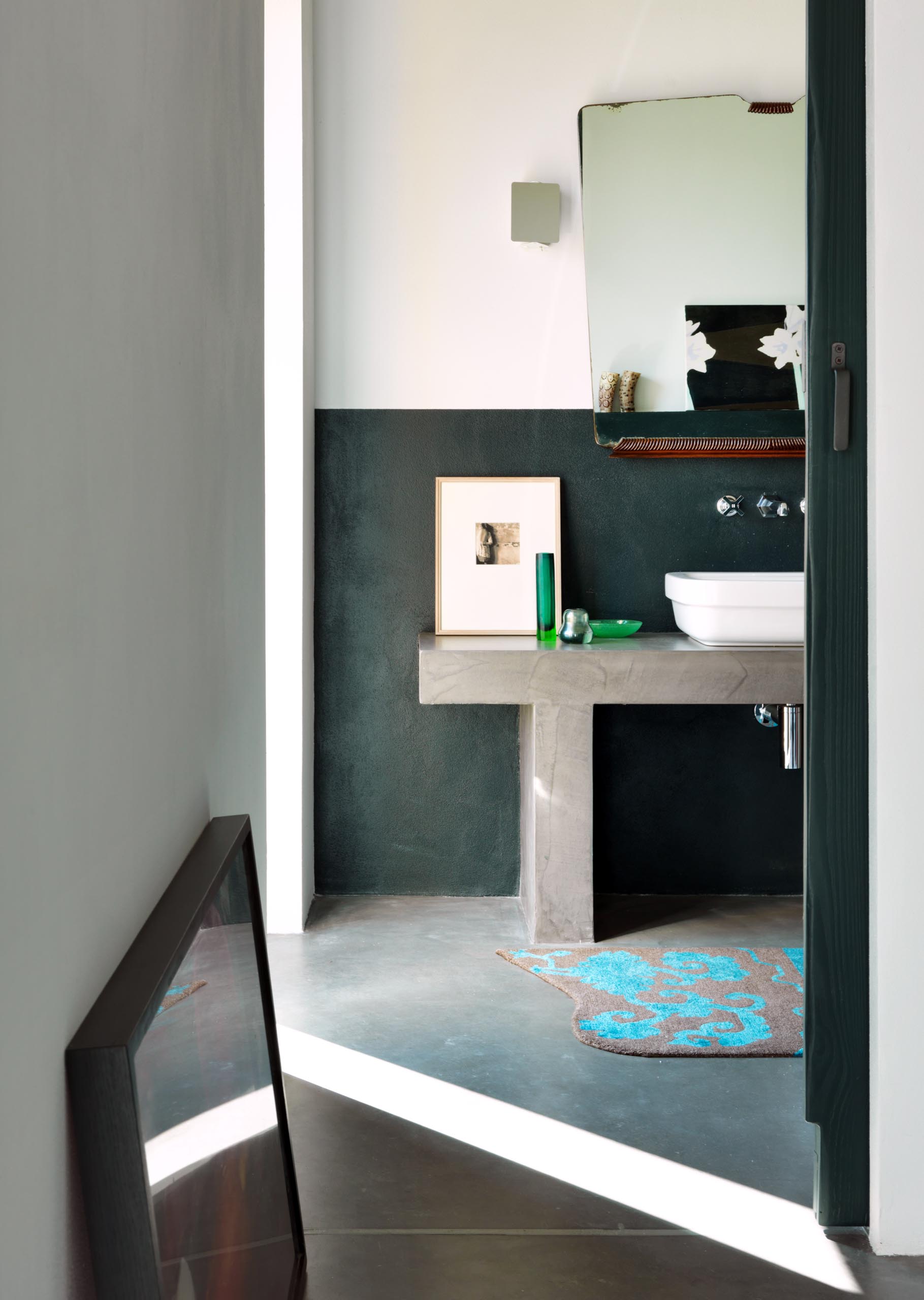 A contemporary bathroom with a partial black accent wall.