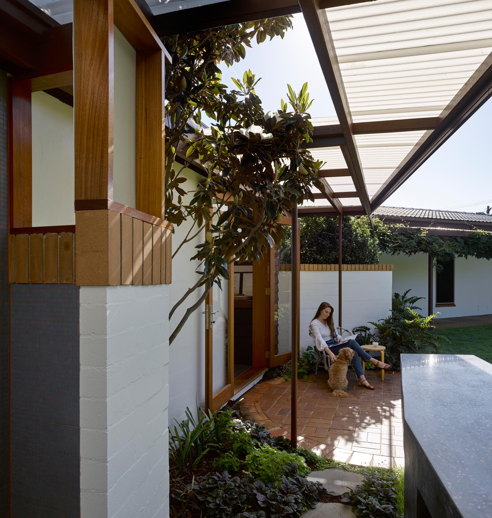 A converted carport with a brick patio.