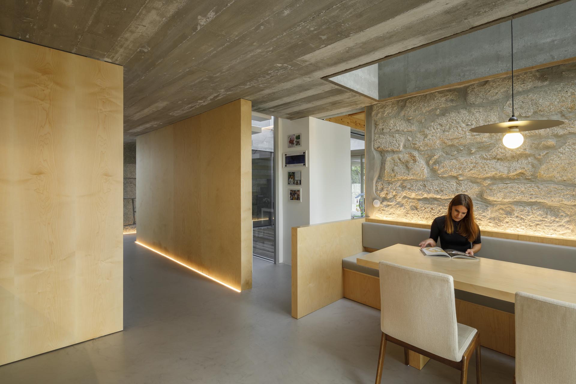 LED lighting strips have been used in this dining area, where the backrest of a banquette bench has been highlighted.