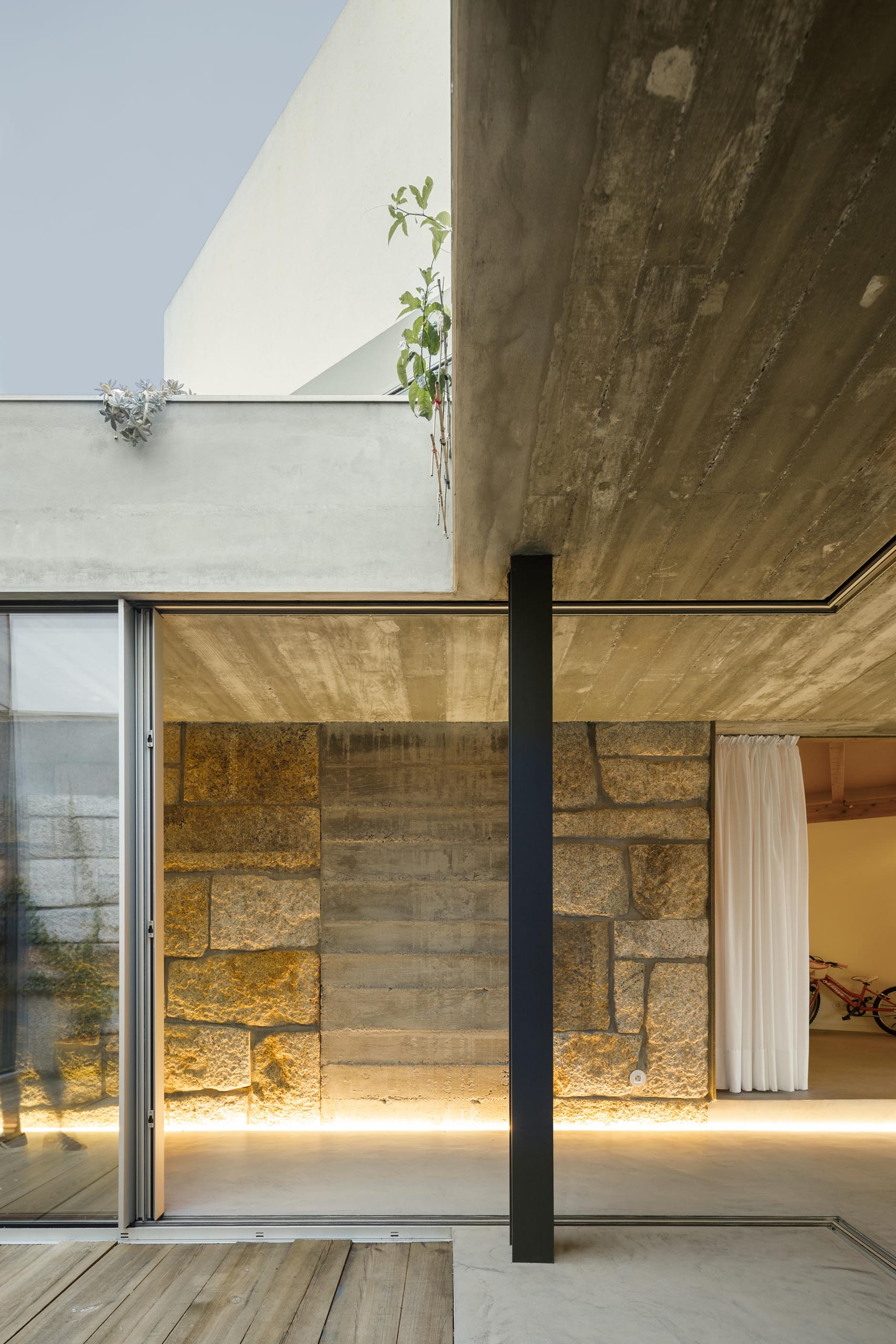 By using illuminated LED strips, the stone, concrete, and wood walls throughout this modern home are able to be showcased in a subtle way.