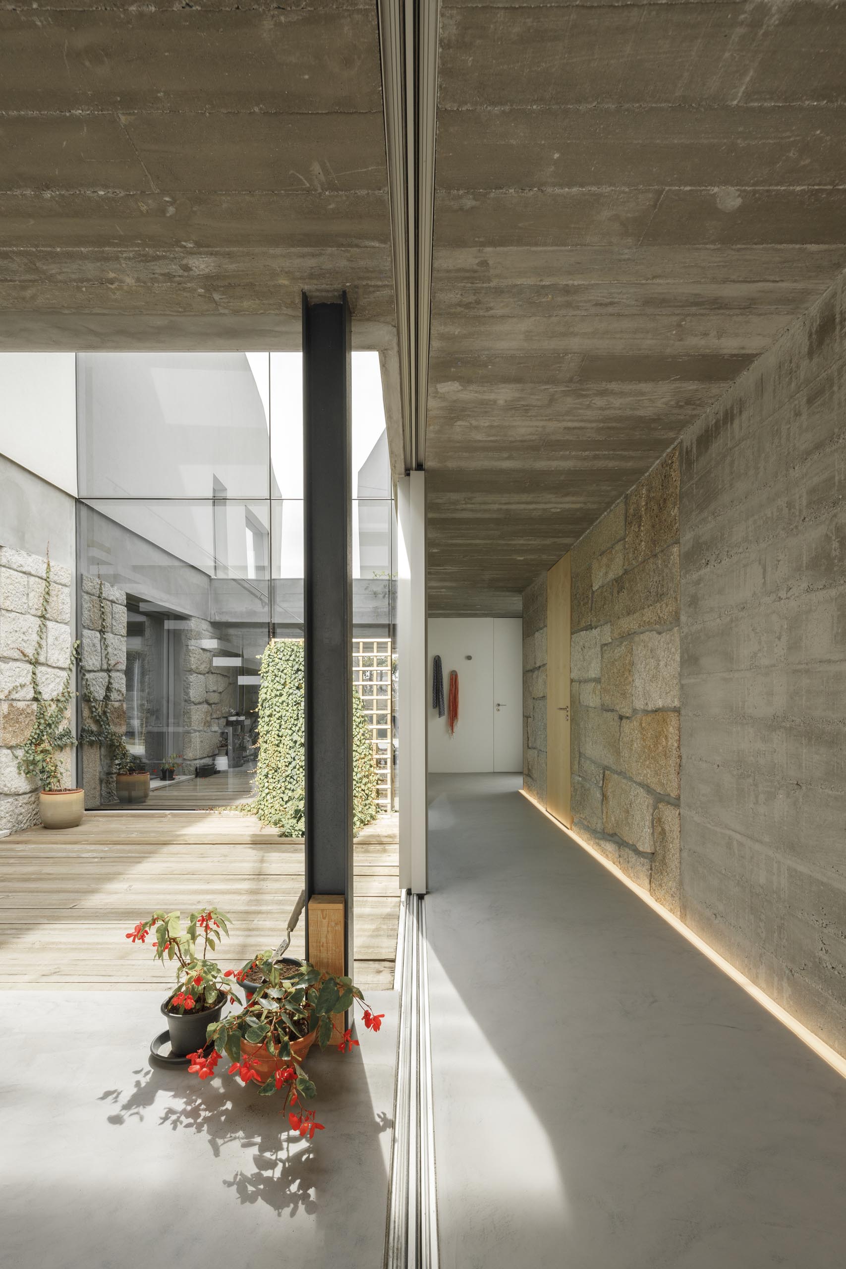 A hallway with stone walls is illuminated by LED lighting on the floor.