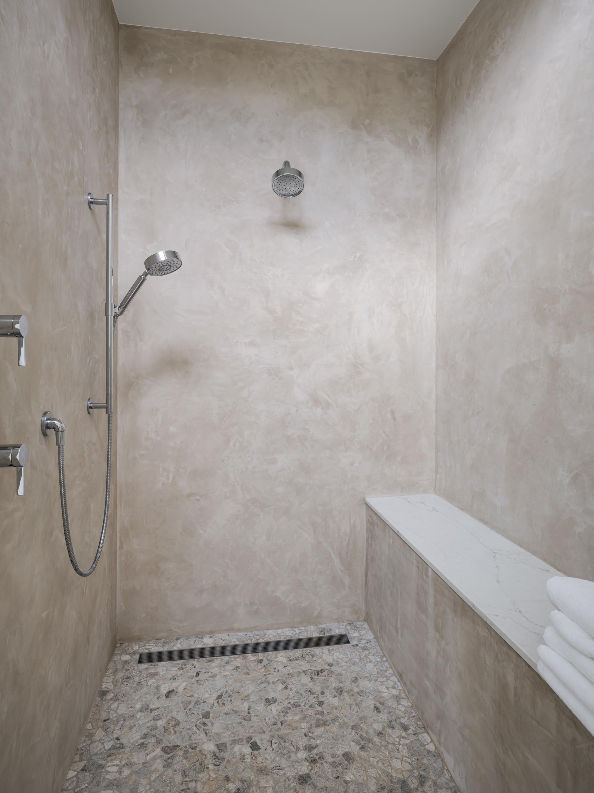 A contemporary shower with a built-in bench.