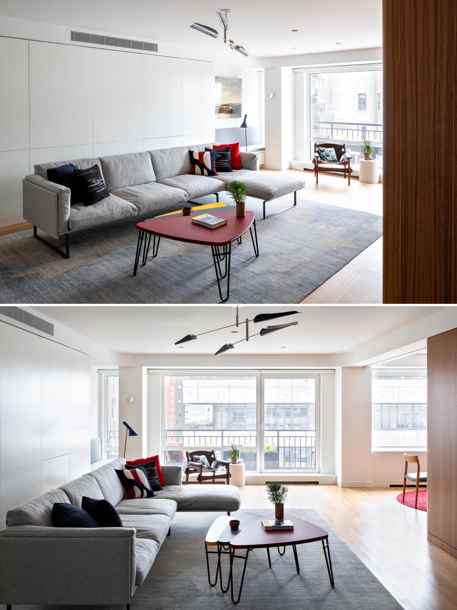 In this modern living room, there's a gray sofa with matching rug and nesting coffee tables with hairpin legs. 