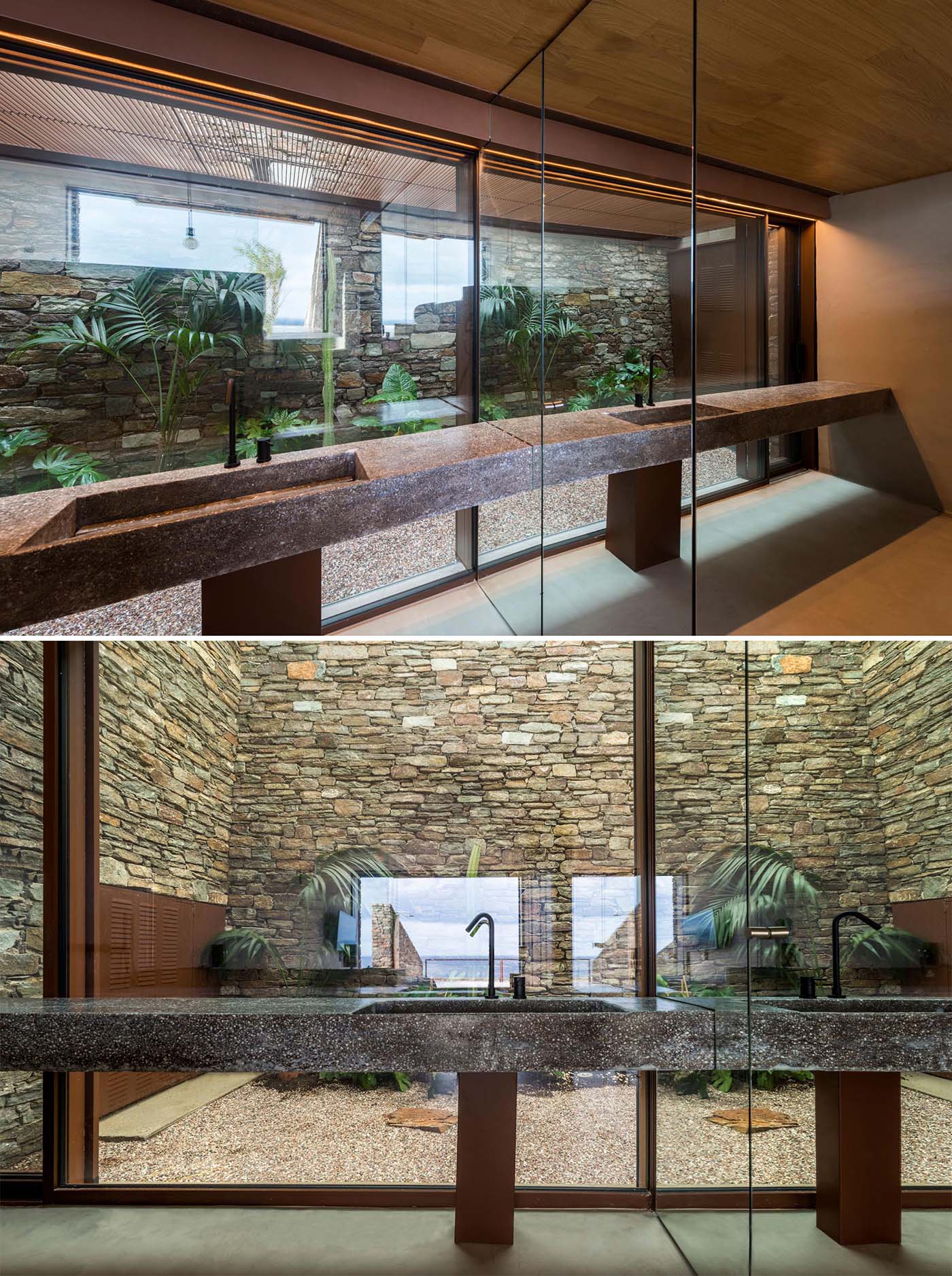 In this bathroom, a glass wall provides a view of a garden and stone wall.