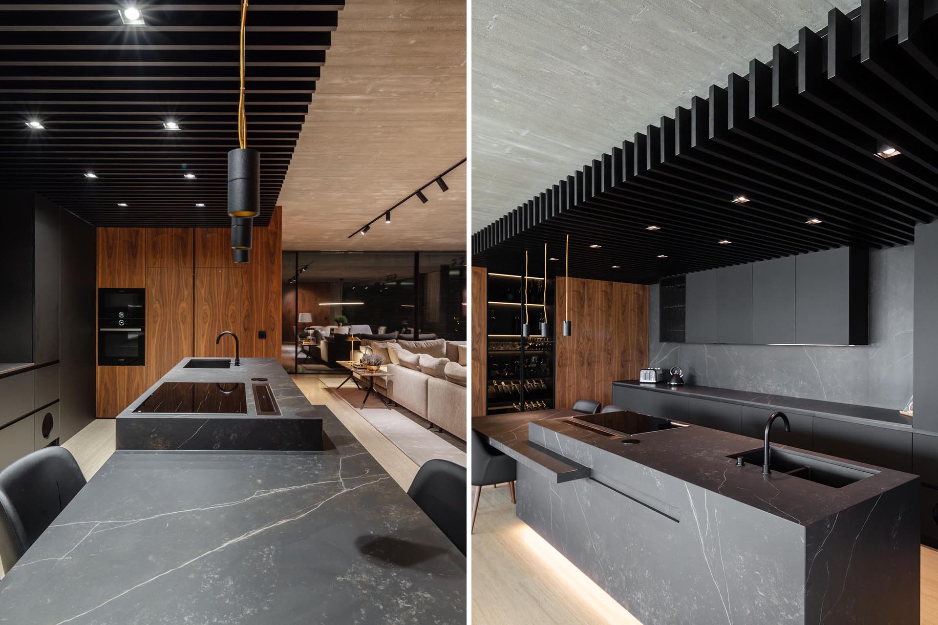 A modern kitchen with a wall of matte black minimalist cabinets, a black wood ceiling, and large island with seating.