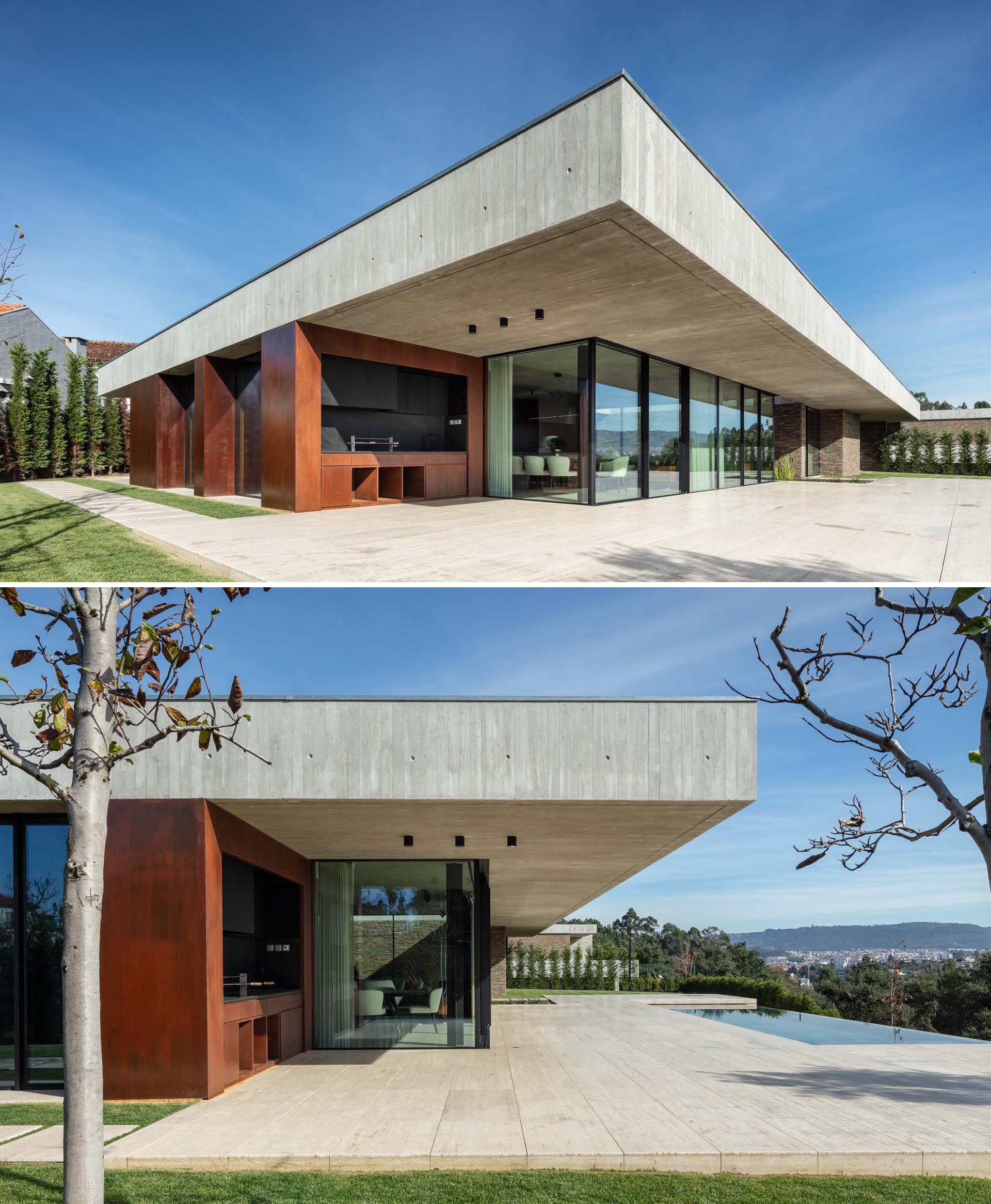 A modern concrete home with glass walls, an expansive patio, and a swimming pool.