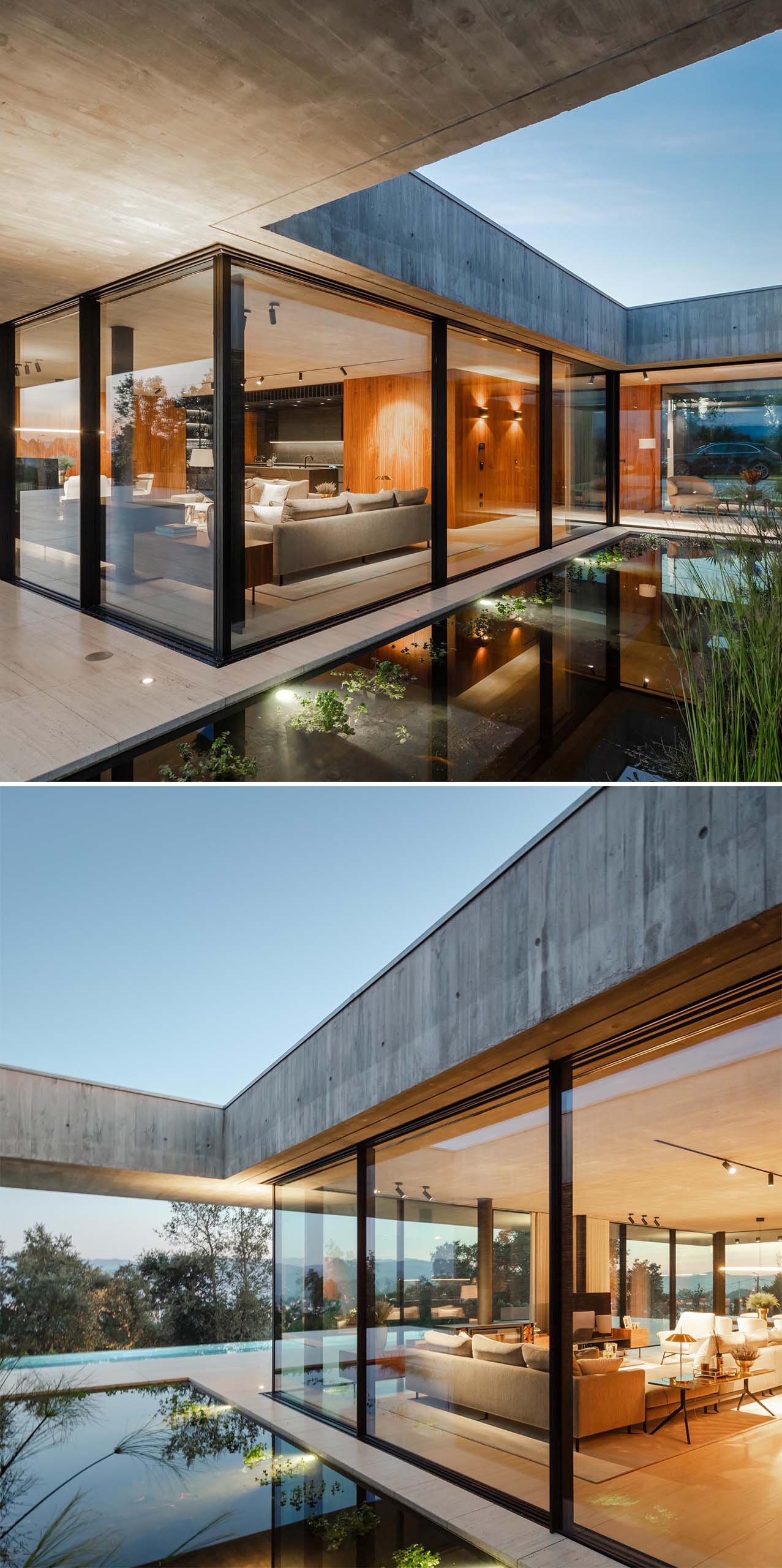 A modern concrete home with glass walls and a water feature.