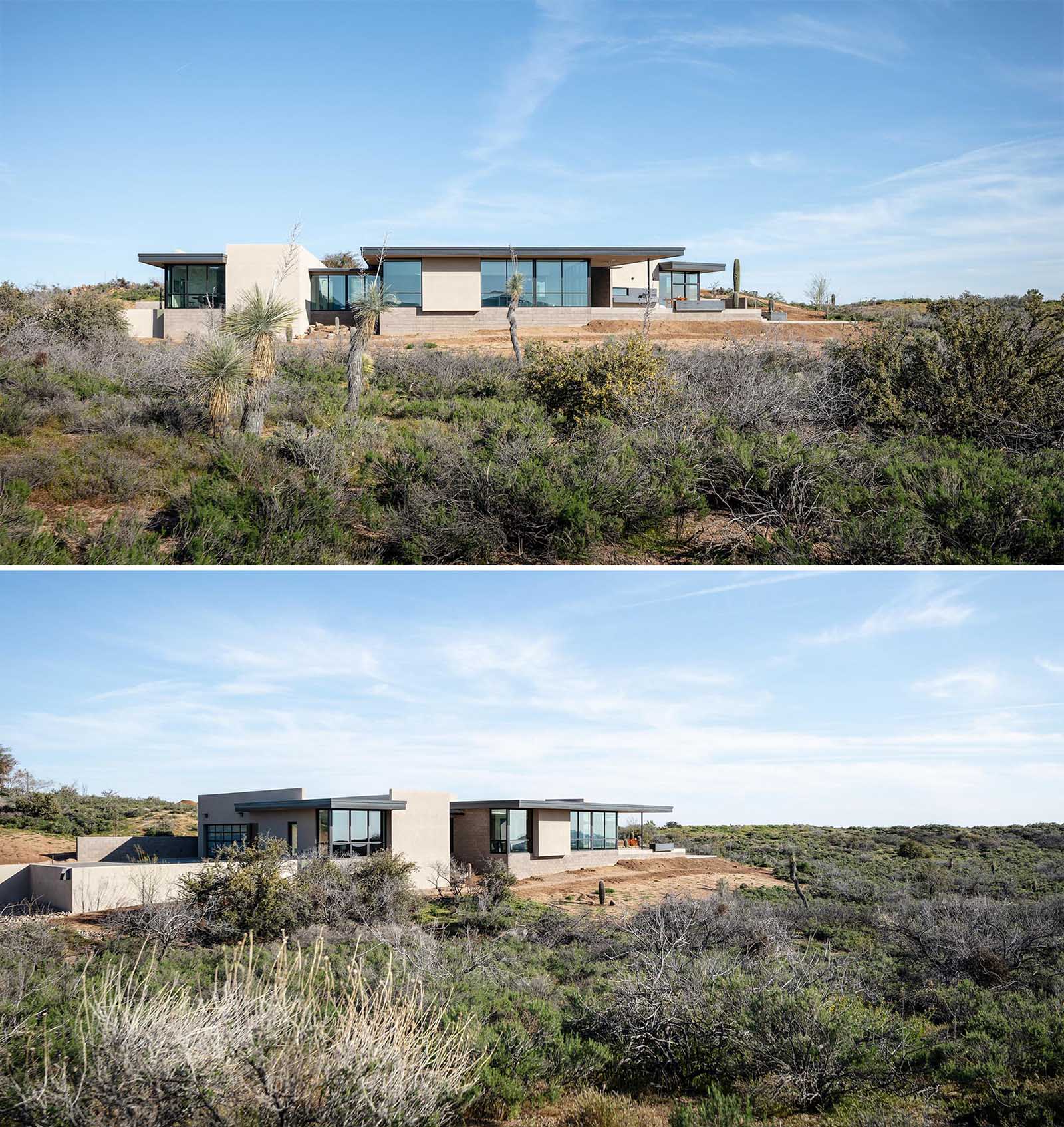 Surrounded by a desert landscape, this modern home has a large roof overhang that helps protect the glass areas from the harsh Arizona sun.