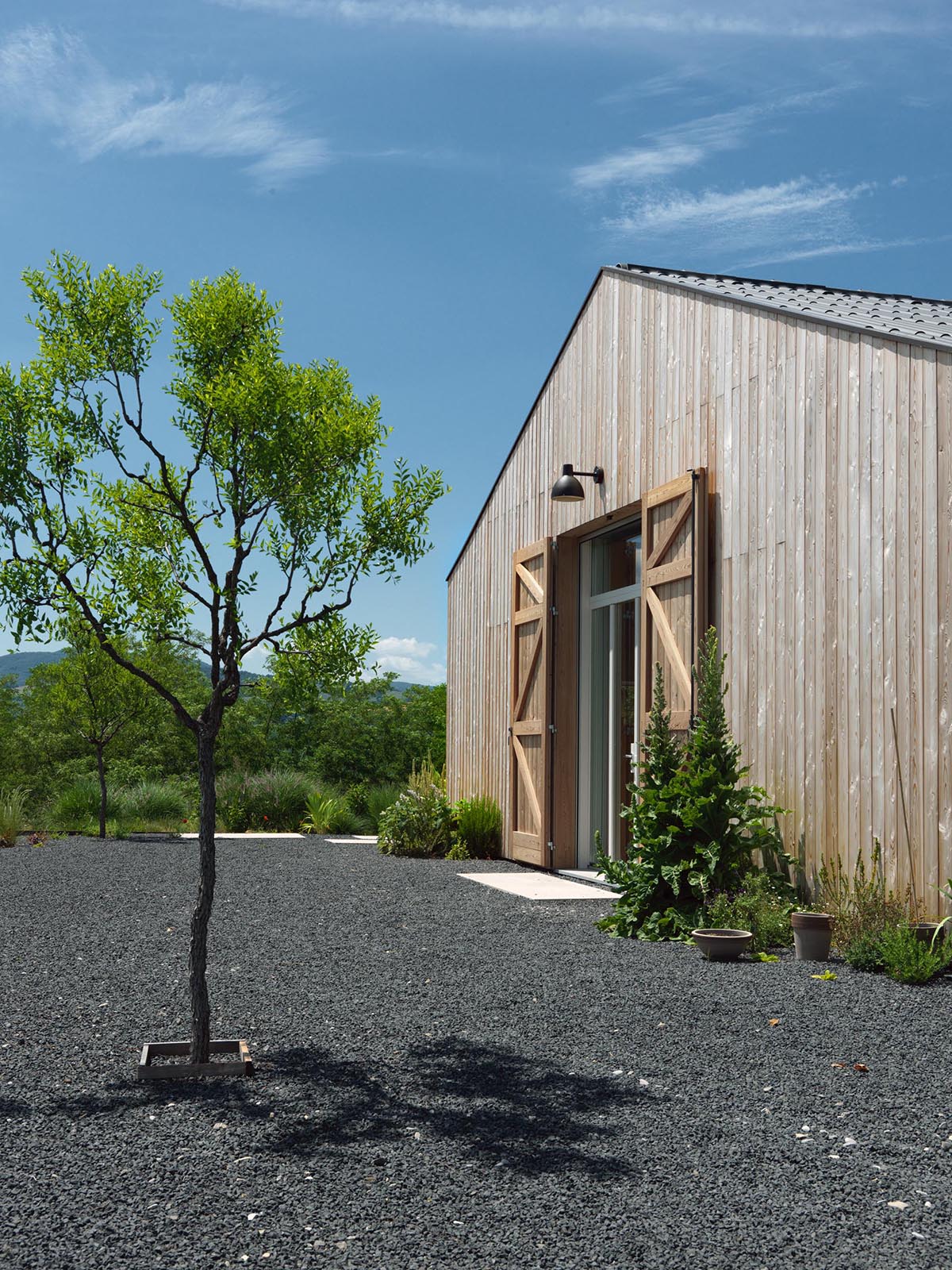 The exterior of this modern farmhouse is clad with natural larch wood.