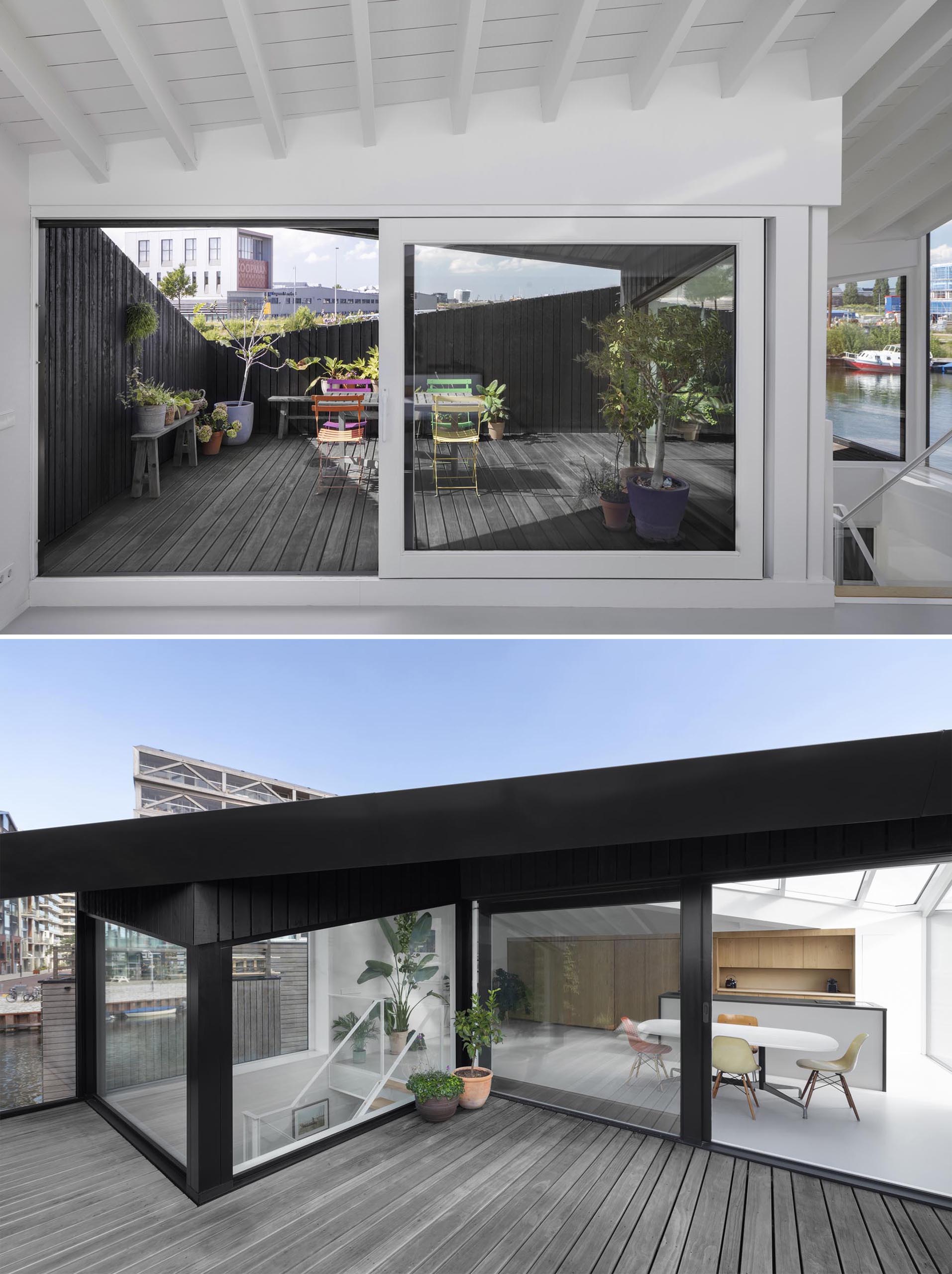 A sliding glass door opens the kitchen and dining room of this modern float home to the rooftop deck.