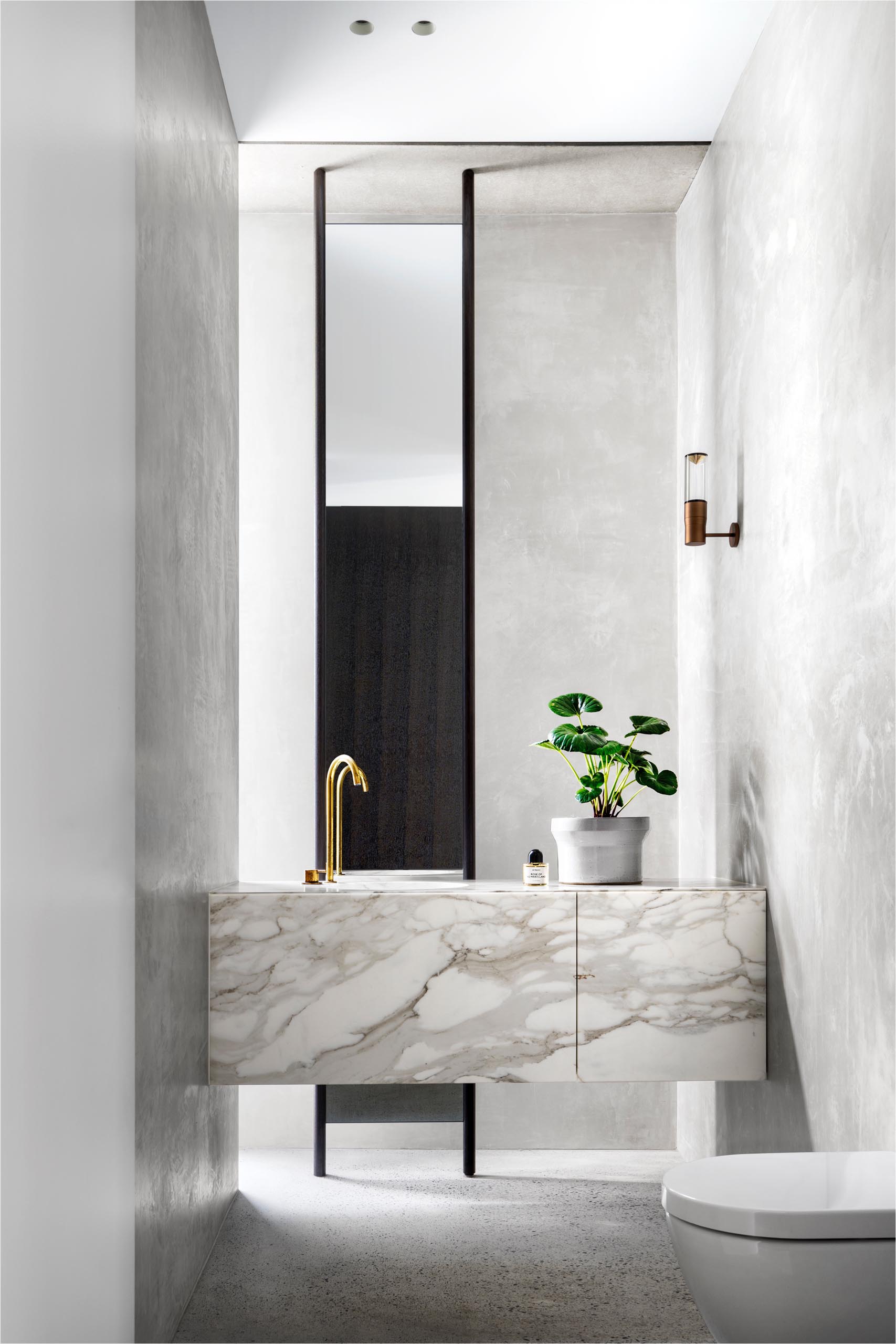 A modern bathroom with a marble vanity.