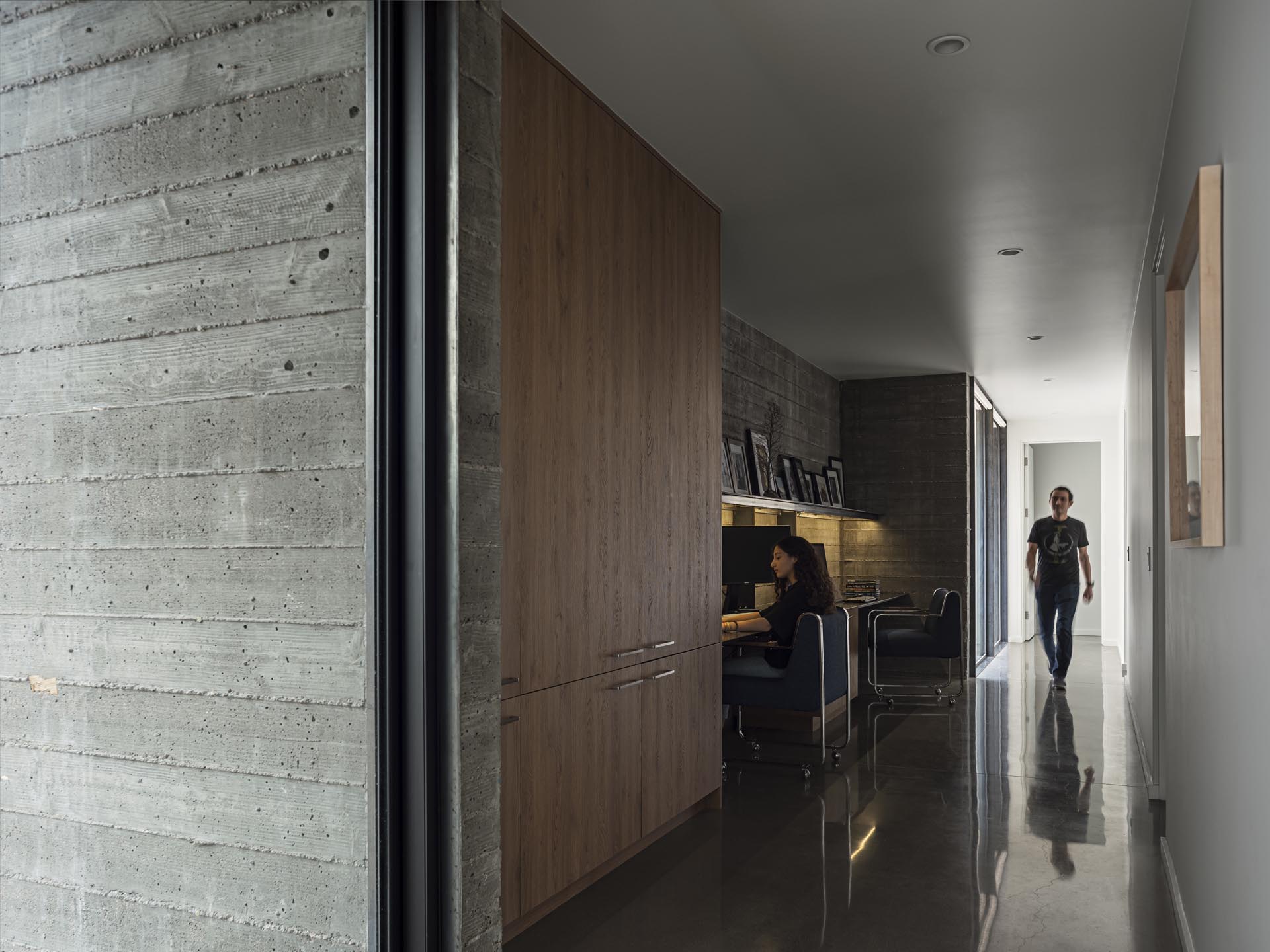 A dedicated homework station is tucked into the hallway of this modern home, and has room for multiple people.